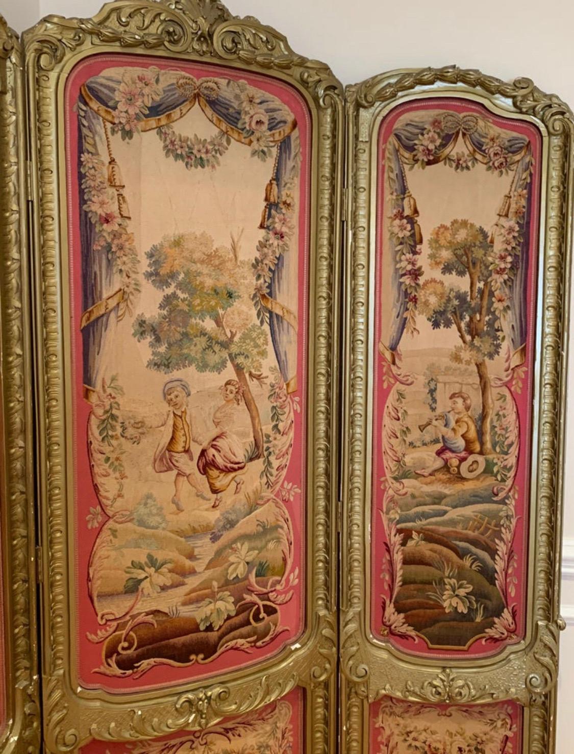 Gorgeous 19th century Louis XV Regency gilded screen and fire screen with Tapestries. The Rococo style tapestries are in pristine condition with very minor loss of gilding to the frames. The larger three panel screen has a pristine pink satin