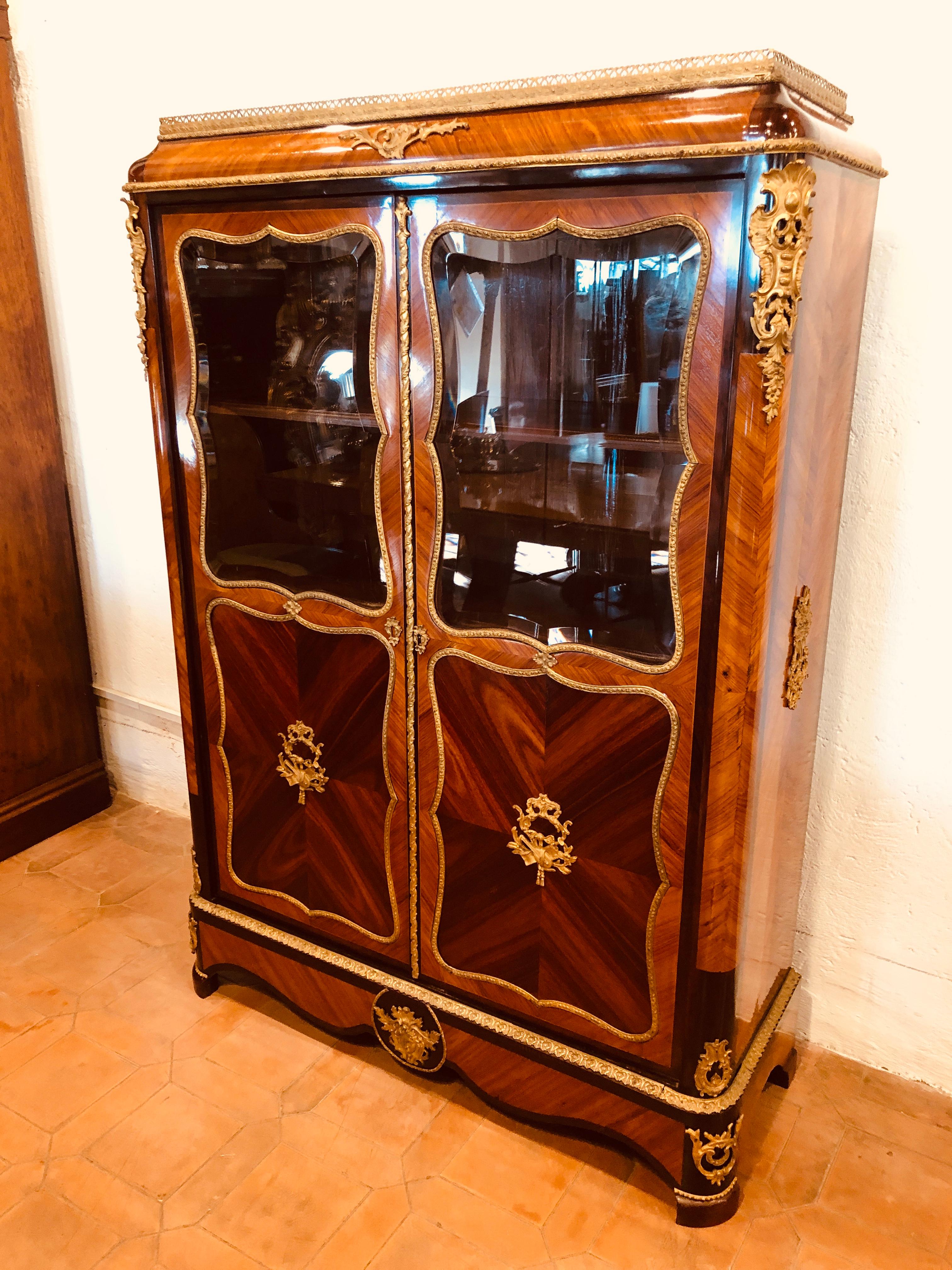 Fantastic cabinet from France, Louis XV style, excellent proportions, fantastic game of wood on the front and on the sides. Purple ebony and rose wood, applications in gilded bronze, circa 1840. Restored.