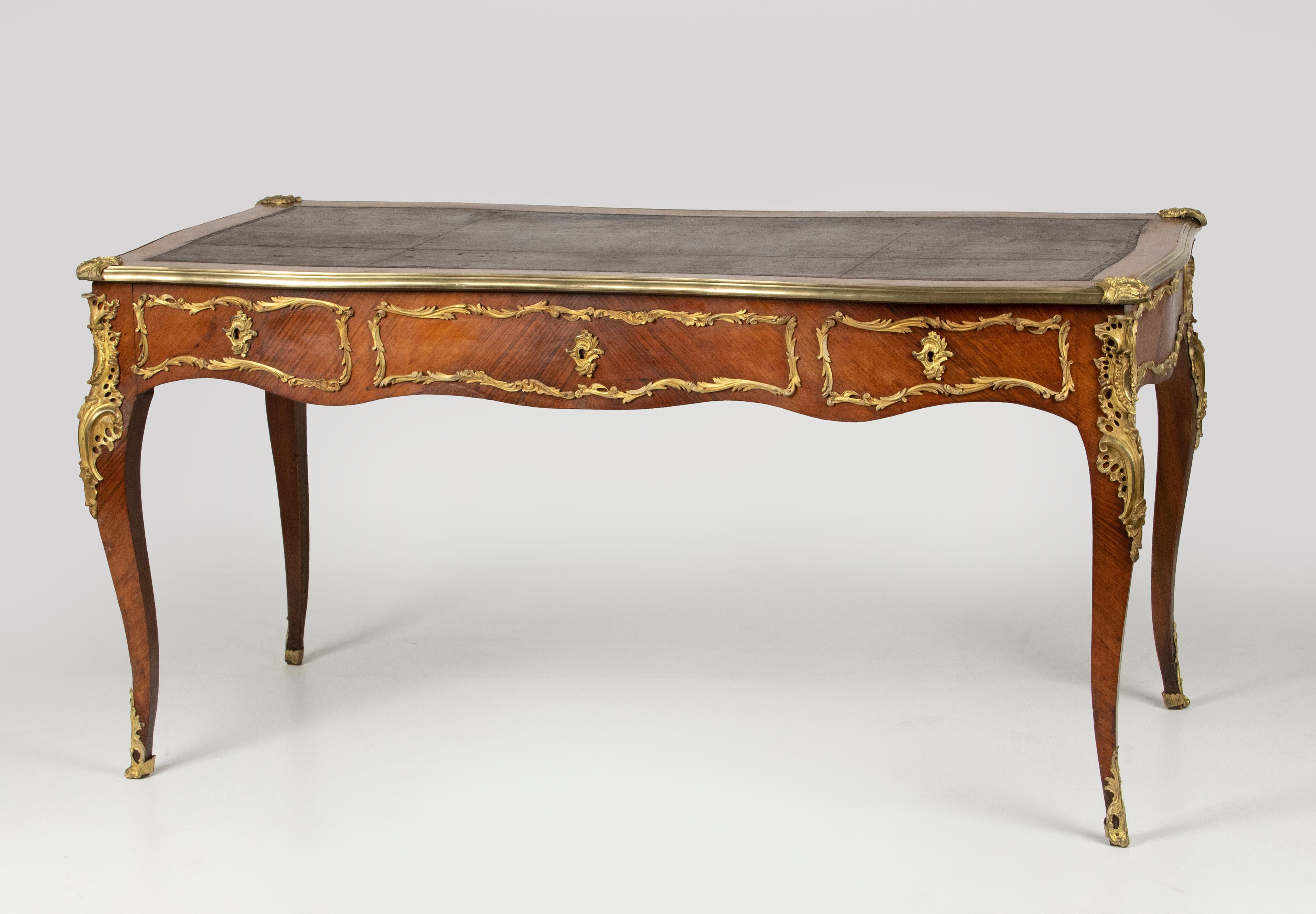 An elegant antique French desk/writing table in Louis XV style. Also called 