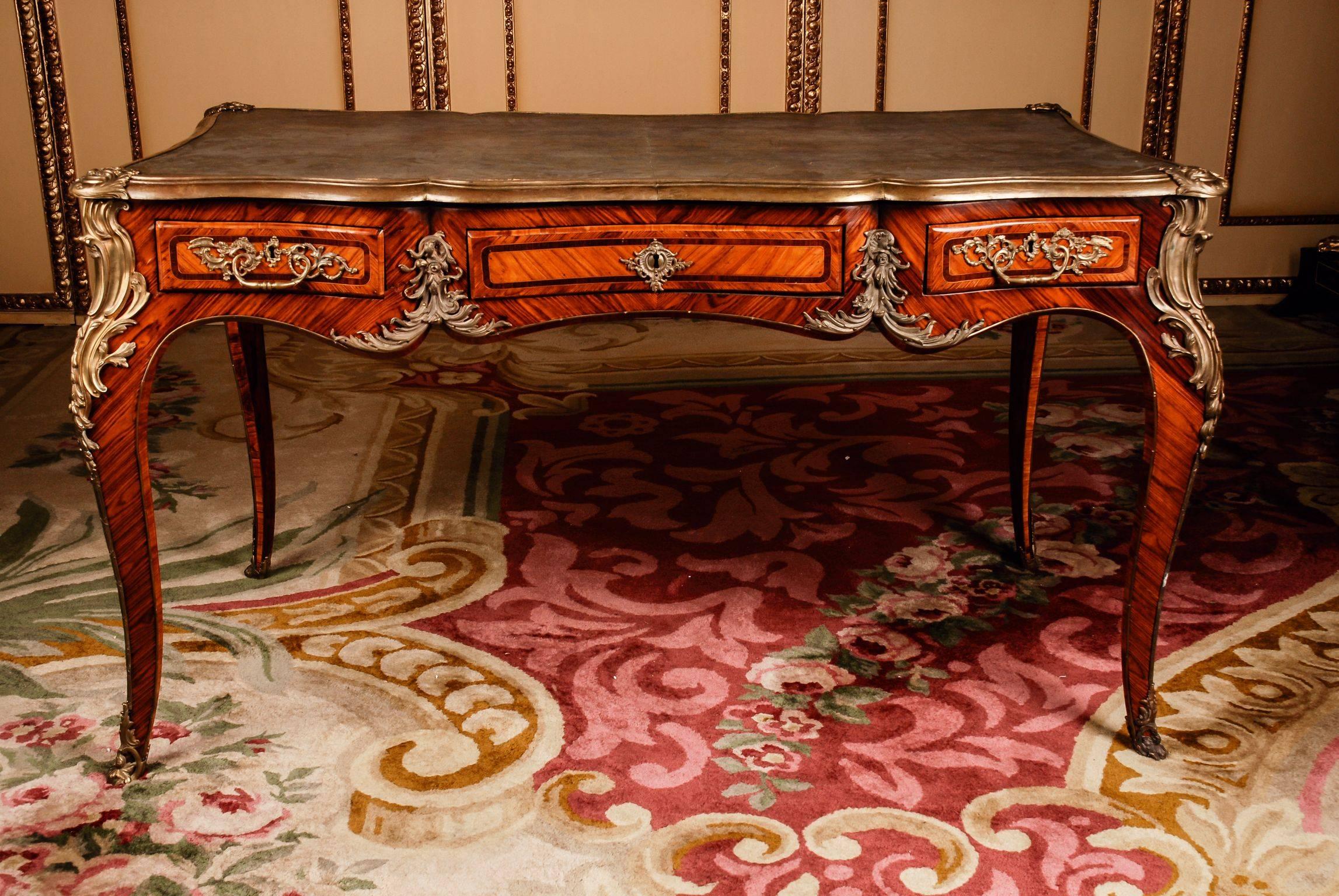 Bureau plat in the style of the Louis XV Napoleon III Paris, circa 1850-1880.
In Bois-Satiné veneer, all-round full-length mirror veneer with seed beads. With very finely chiselled, highly decorative, restrained fire-gilt bronze fittings. Solid