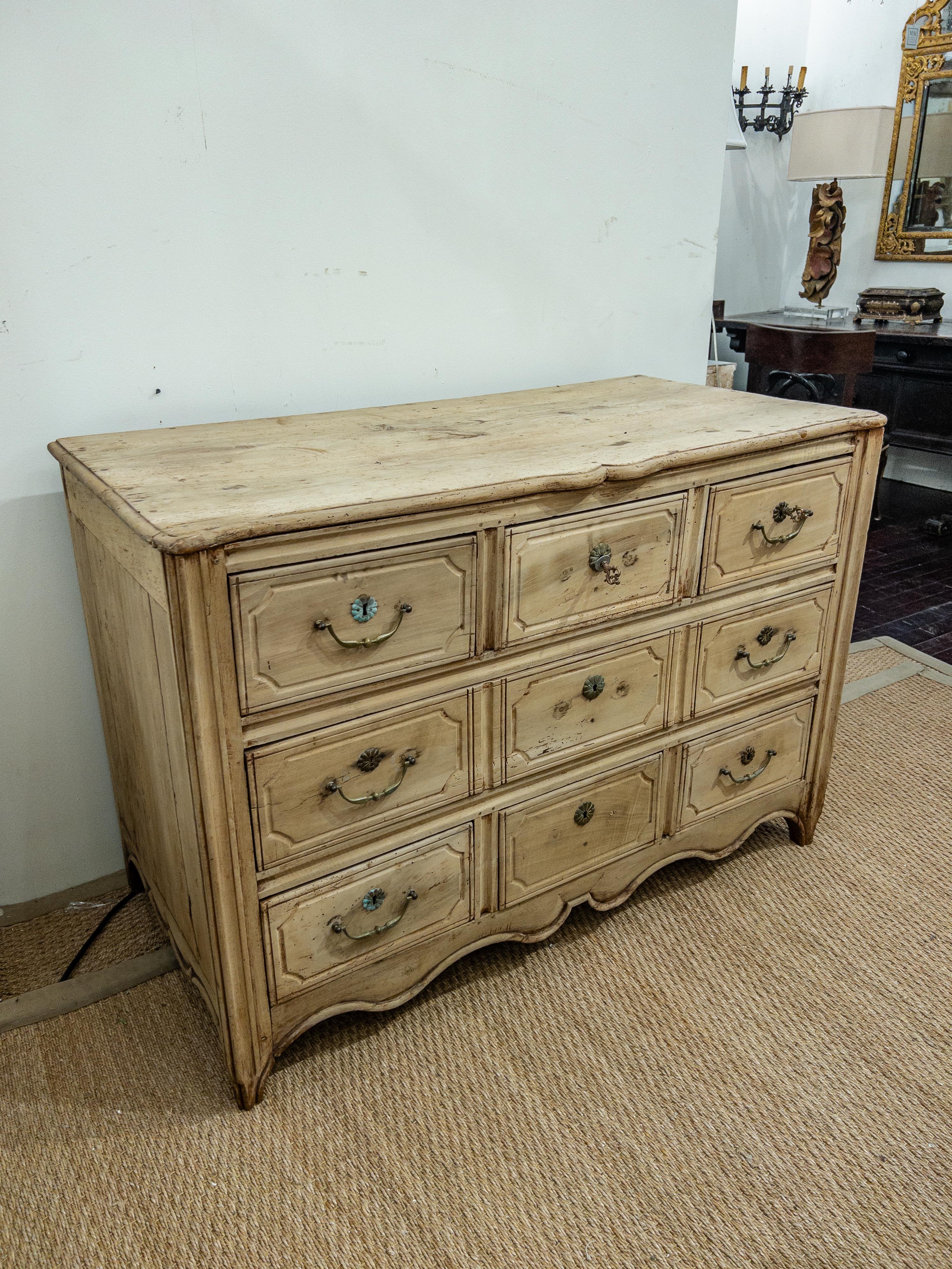 The 19th-century Louis XV style French commode is an elegant and ornate piece of furniture. It is crafted from lightened walnut, giving it a beautiful and warm hue. The commode features brass hardware, adding a touch of luxury and sophistication.