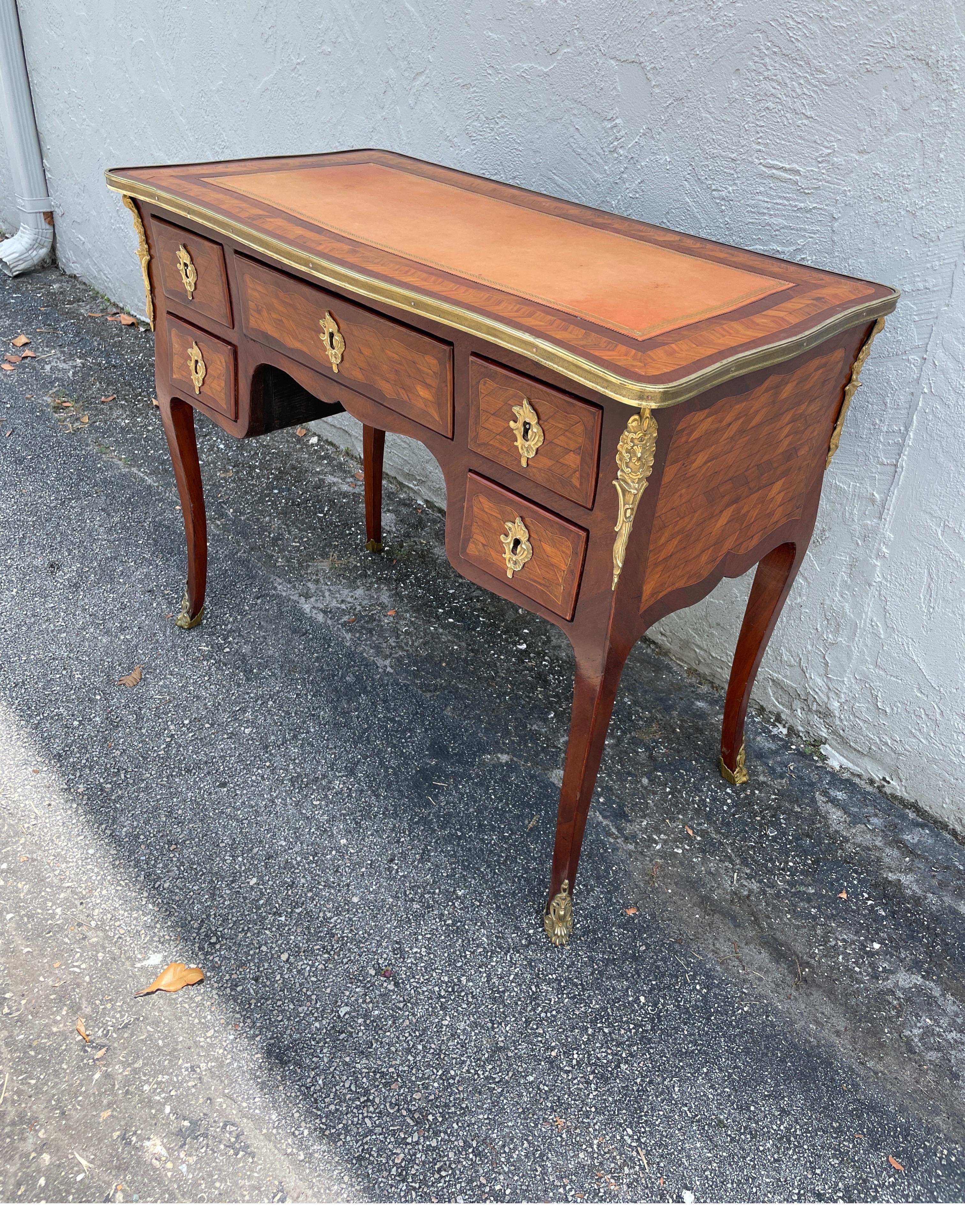 French Louis XV style Marquetry desk with embossed leather top.