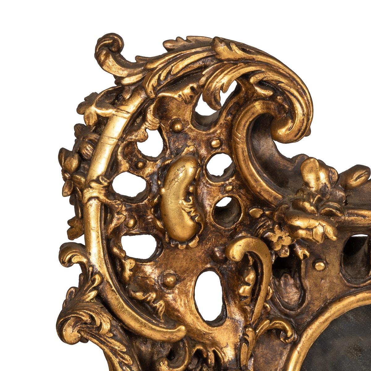 Antique 19th Century French Louis XV style mirror surrounded in an extravagant gilt wood Rococo style frame. Beautiful elaborate carvings including floral and scroll designs on matted ground.

CONDITION
In Great Condition - No