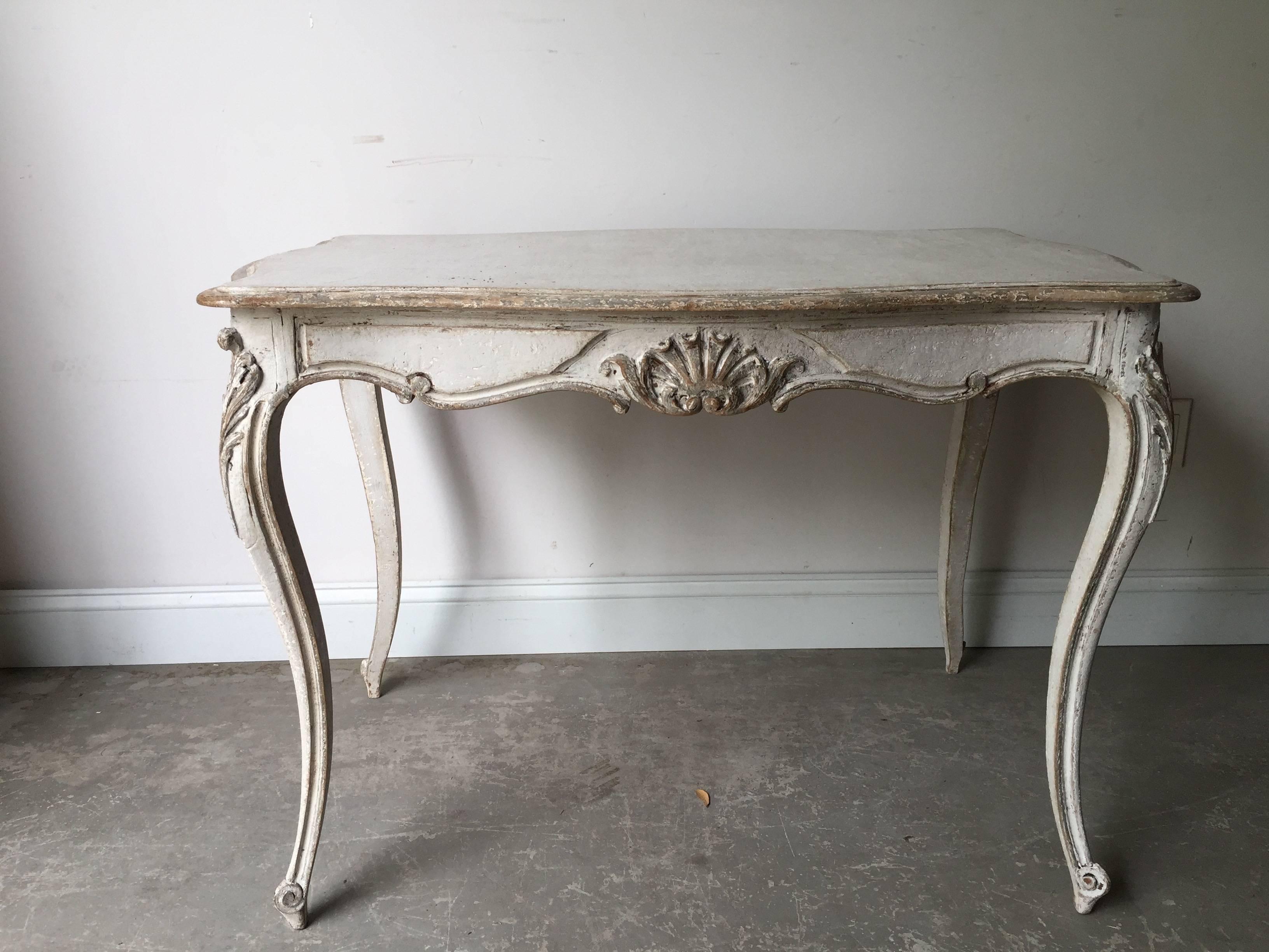 A charming 19th century Louis XV style table/center/desk has slender cabriole legs with carved knees, and a carved flower motif centering sides of shaped apron. One drawer on one side.
Surprising pieces and objects, authentic, decorative and rare