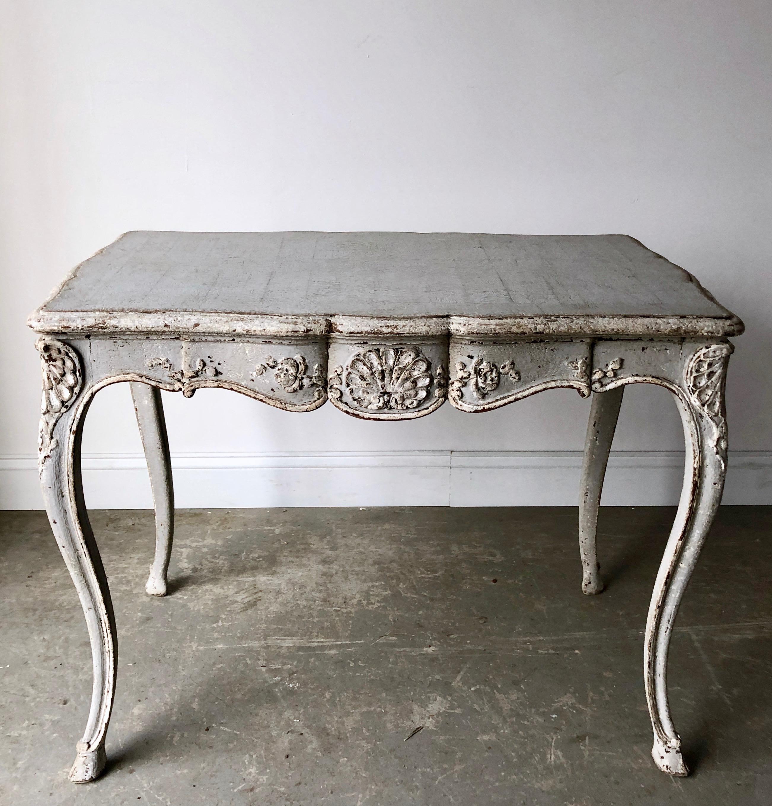 A charming 19th century Louis XV style table/centre/desk has slender cabriole legs with carved knees, and a carved flower motif centring sides of shaped apron. One drawer on one front apron.
Surprising pieces and objects, authentic, decorative and