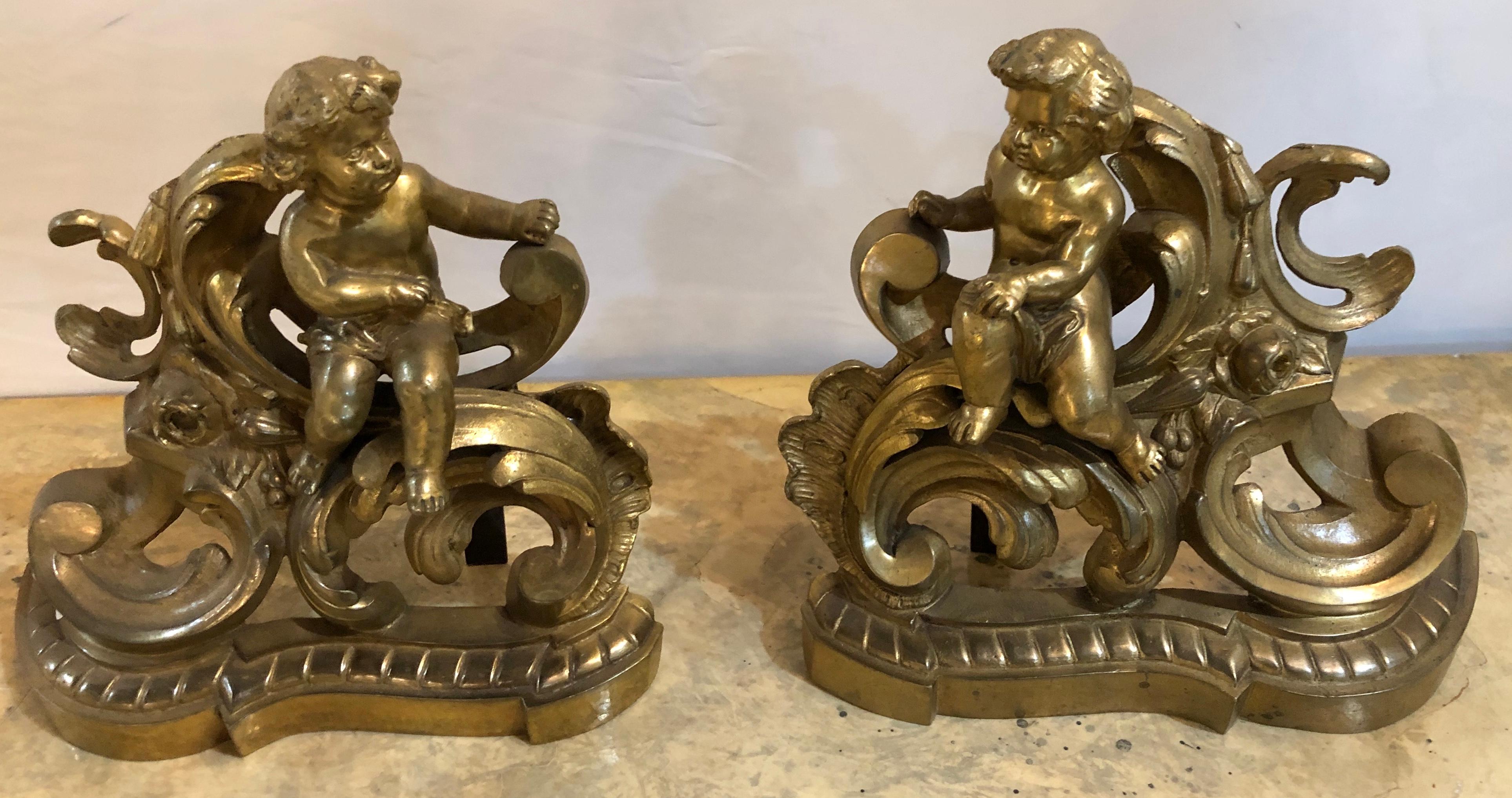 19th century Louis XV style pair of bronze Cherub andirons. Each cherub face the other. 

IXX.