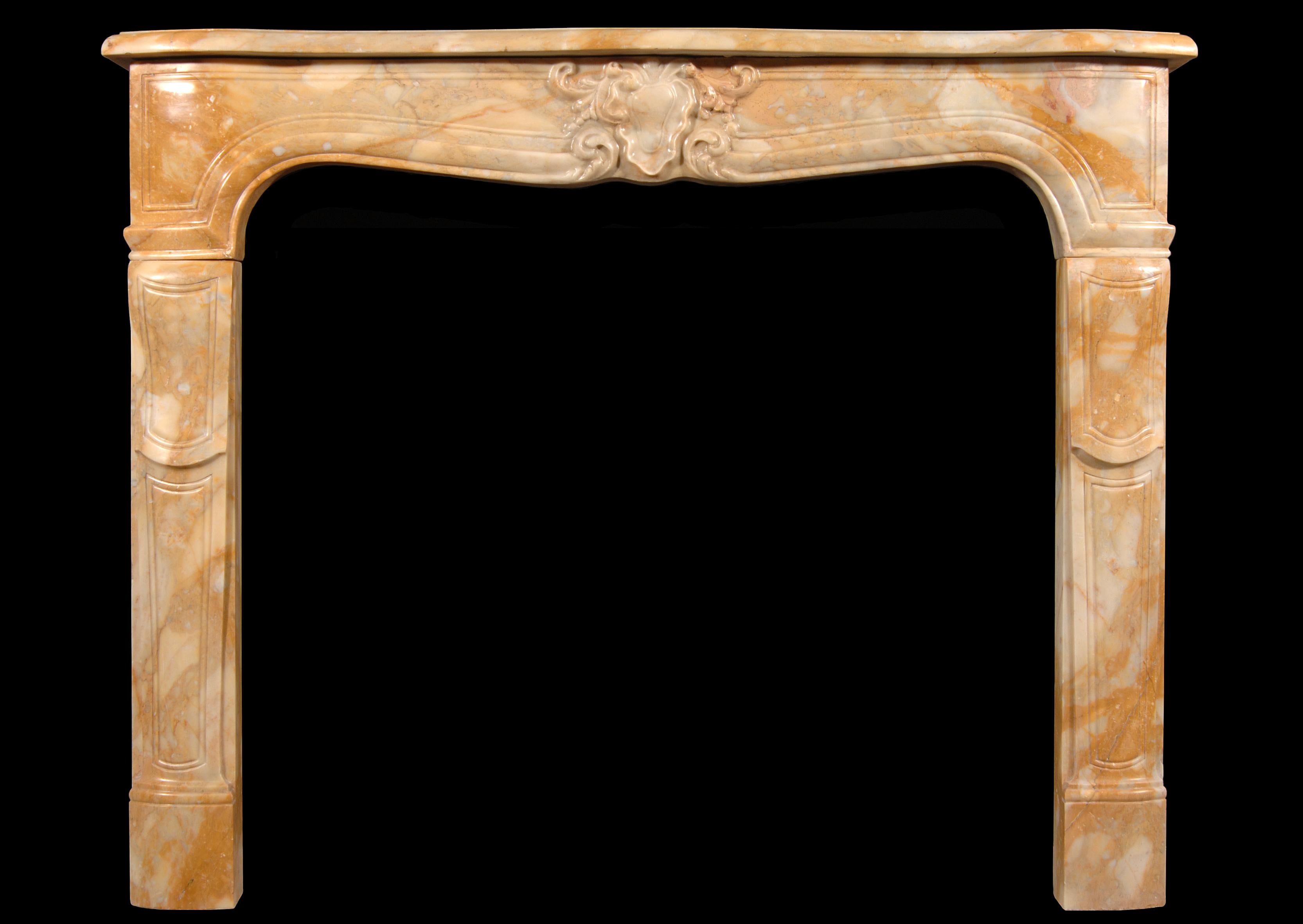 A 19th century Louis XV style Sienna marble fireplace, with carved motif to centre of shaped panelled frieze. Shaped jambs, with serpentine shelf.
 
Measures: 
Shelf Width:	1385 mm      	54 1/2 in
Overall Height:	1120 mm      	44 1/8 in
Opening