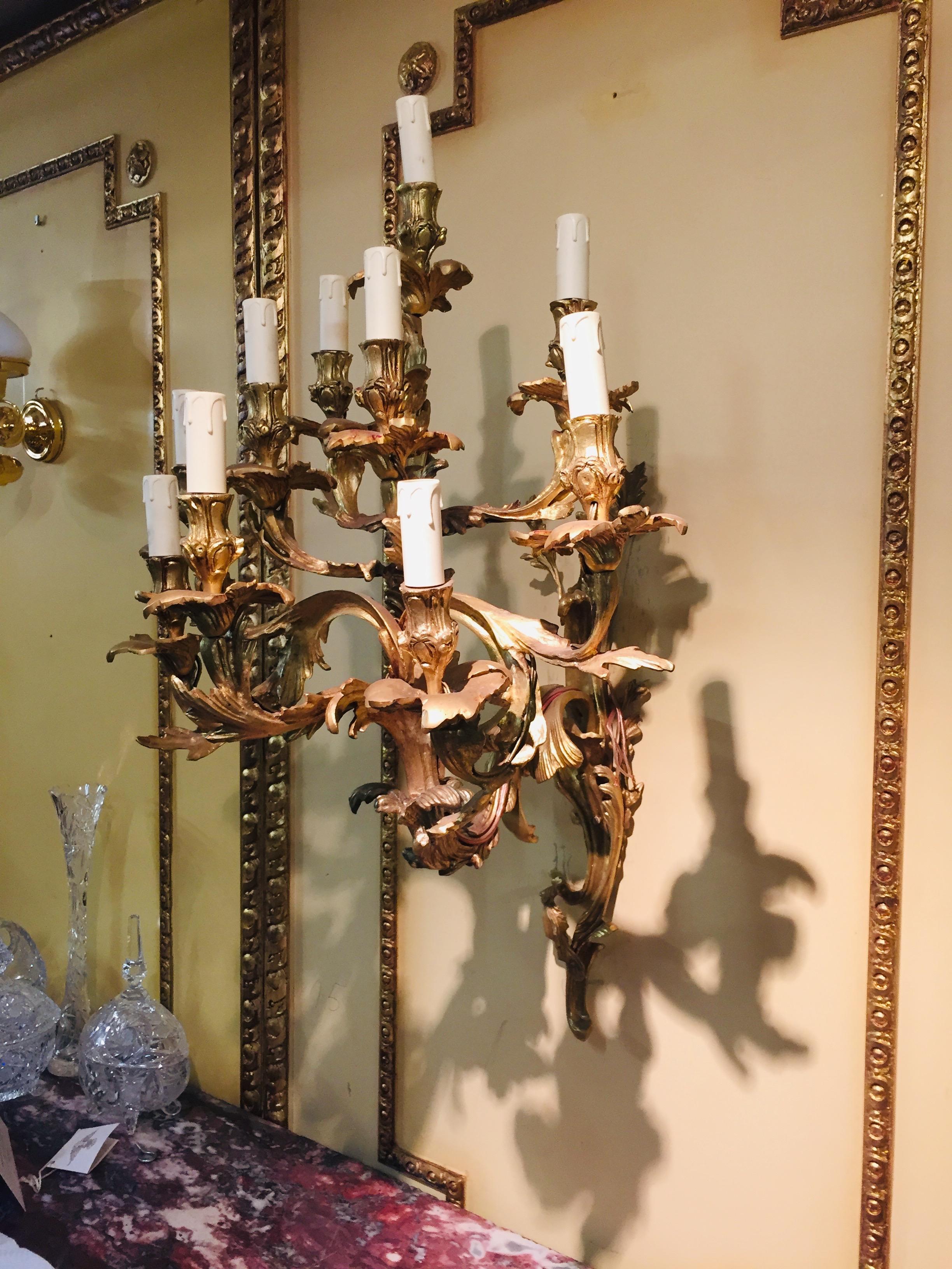 An important, monumental Rococo wall applications in the style of the 18th century. Ten-lighted Luminaire. Bronze chiselled. Flat wall sign made from reliefed volutes and acanthus leaves. In the middle of it, ten curved luminaries with an analogous