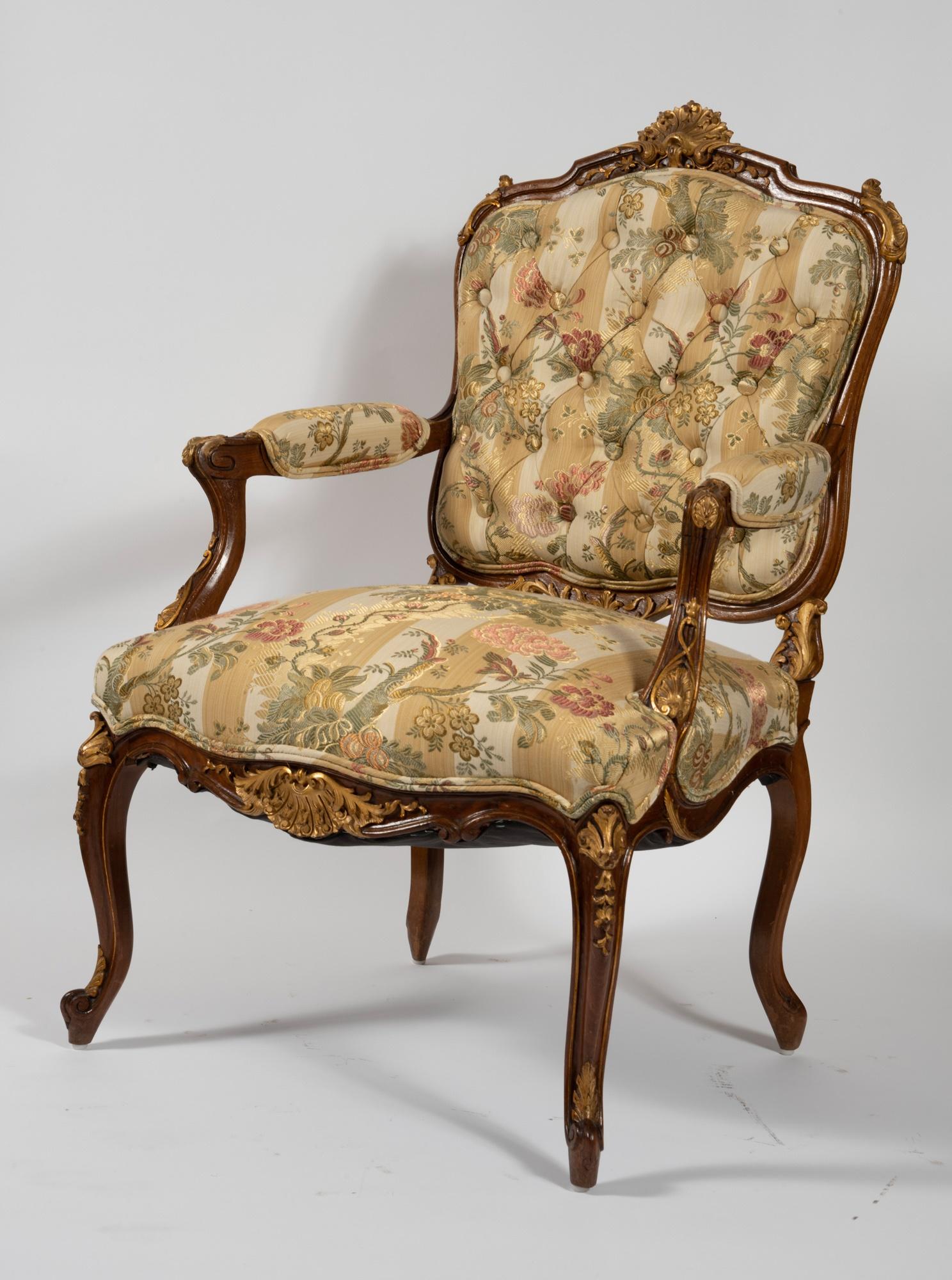 Immerse yourself in the opulence of our exquisite mid 19th-century French Louis XV parcel gilt walnut patinated framed bergères armchairs. This decorative pair showcases unparalleled craftsmanship and timeless design, making them a statement piece