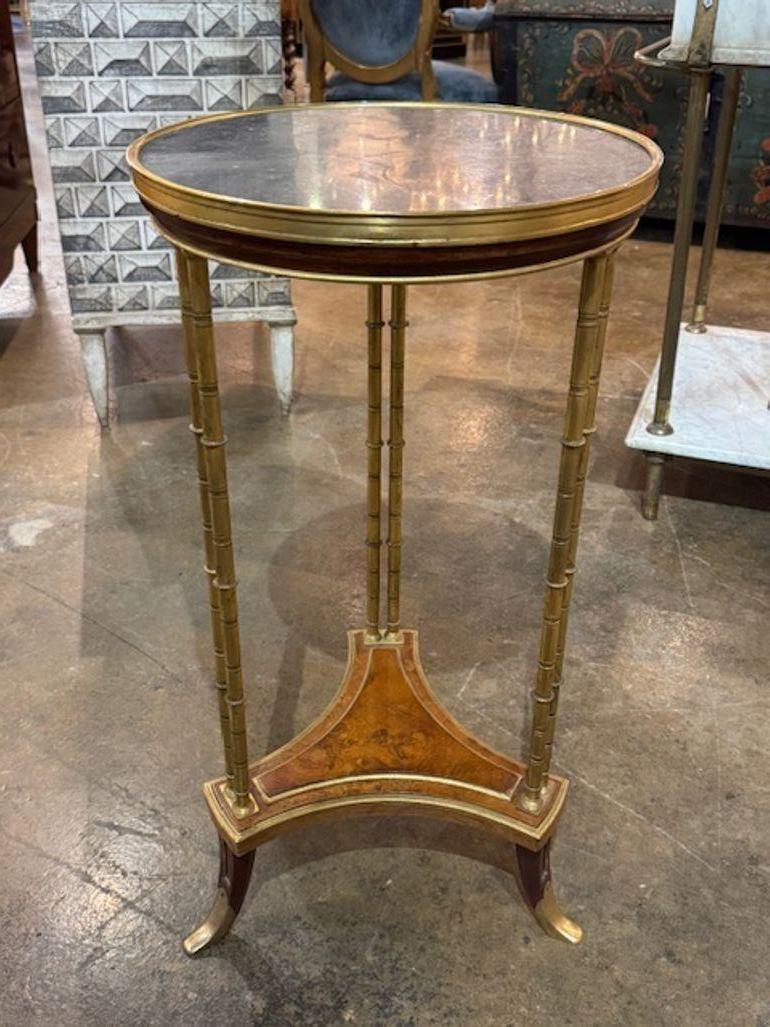 This 19th Century Louis XVI bamboo form side table with an inset marble top is a luxurious and elegant piece of furniture. The intricate design and high-quality materials used in this table reflect the craftsmanship and refinement of the Louis XVI