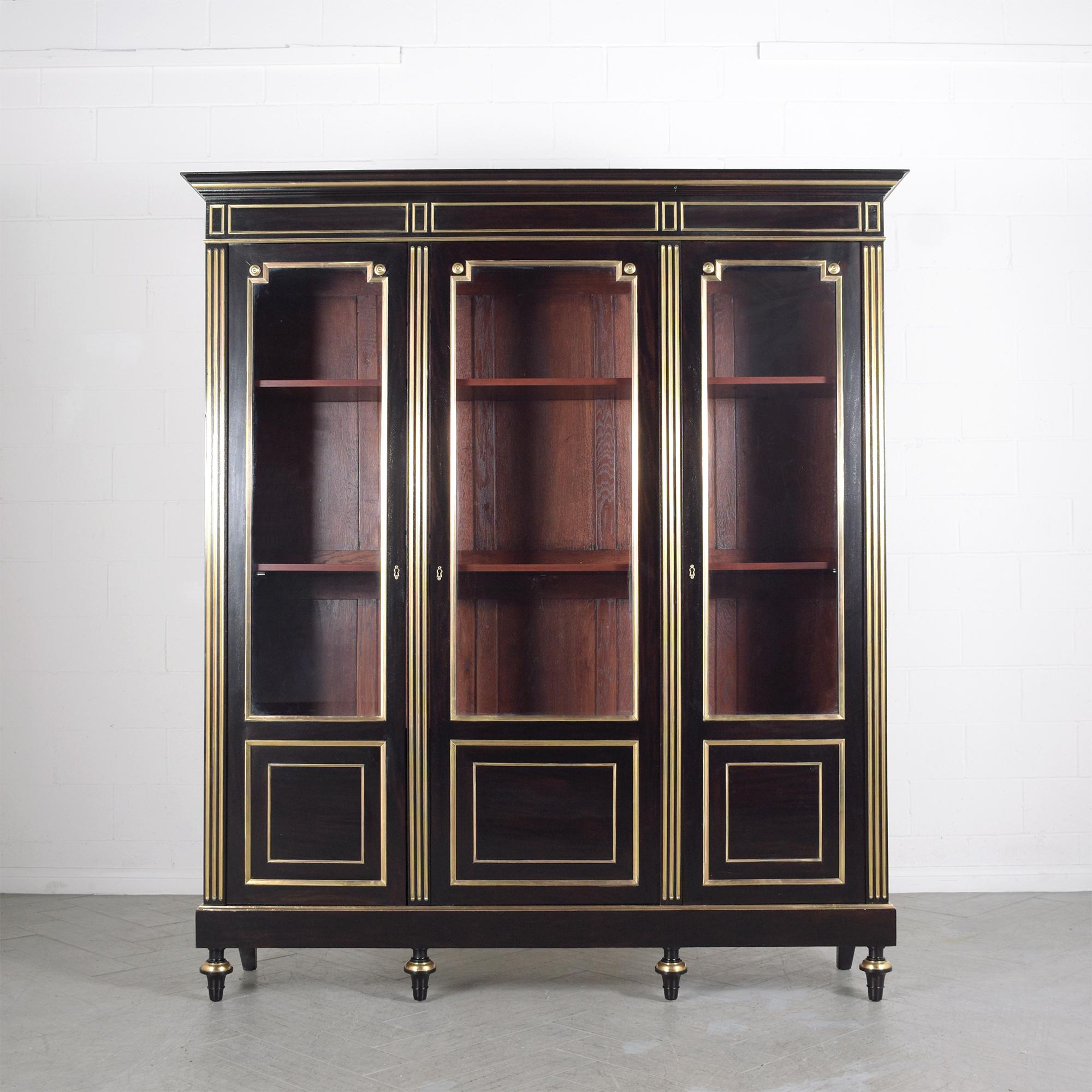 Immerse yourself in the grandeur of French elegance with our stunning antique 1870s Louis XVI bookcase. Handcrafted from the finest mahogany wood, this piece has been lovingly restored by our expert craftsmen to its original splendor, now radiating