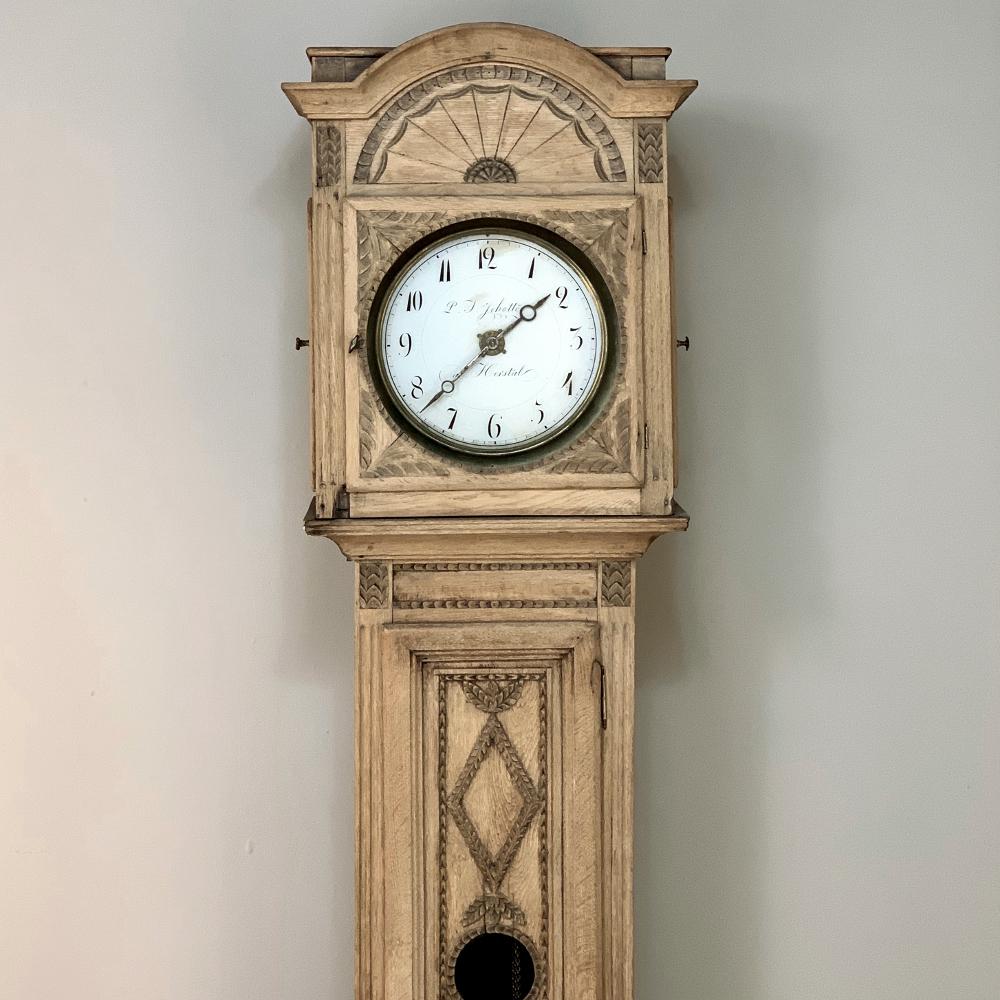 19th century Louis XVI clock by Schotte of Herstal features a tailored enameled dial surrounded by exceptional hand carved artistry, made even more impressive considering the relatively primitive tools at the disposal of the wood crafters of the