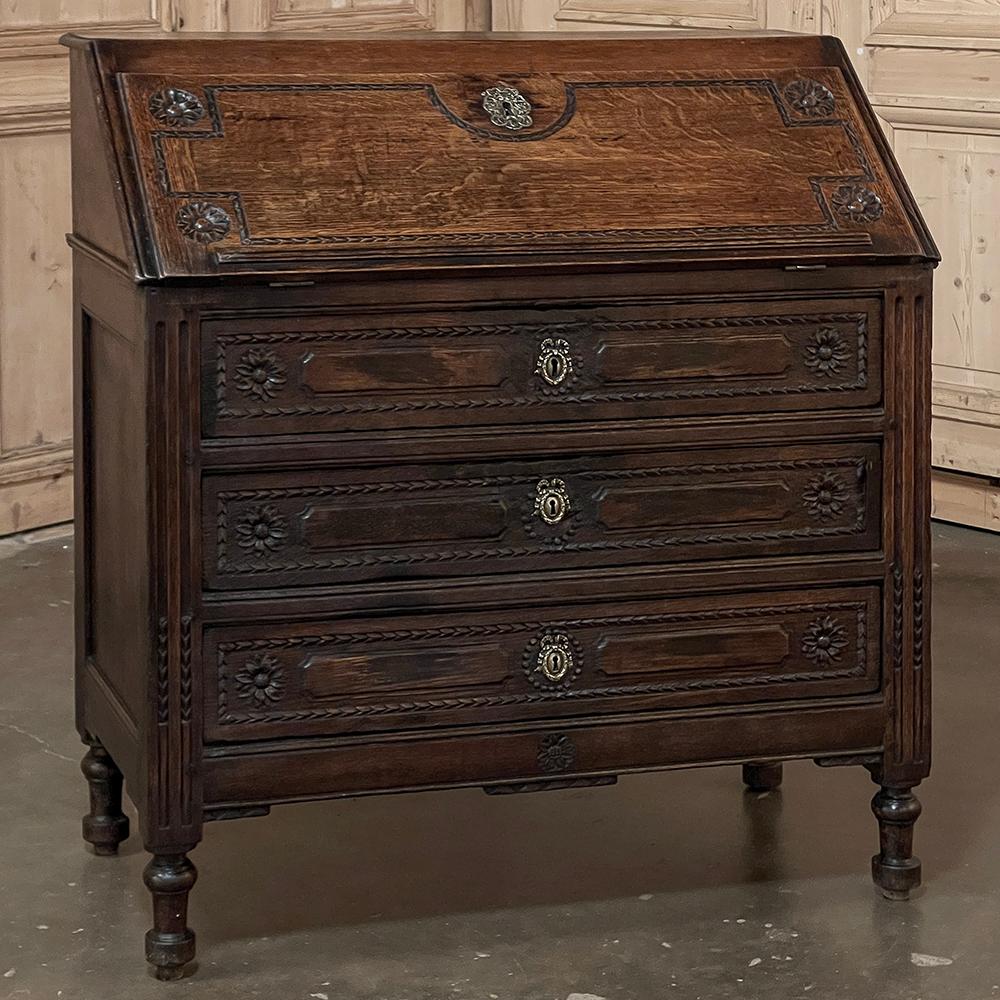 19th Century Louis XVI Country French Secretary Desk is the epitome of efficiency with style!  Artfully hand-crafted from dense, old-growth oak, it features a slant front design where the front hinges open to produce a brass-arm braced writing