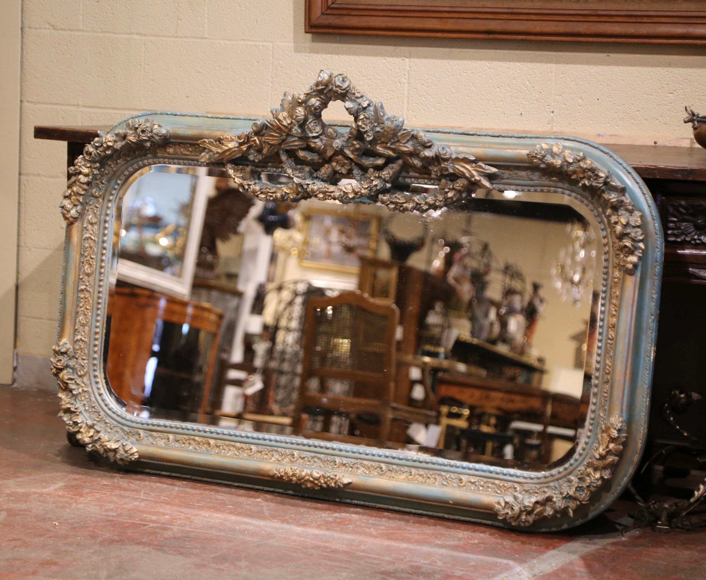 Decorate a entryway or living room with this large antique painted mirror. Crafted in France circa 1880 and almost five feet wide, the frame features intricate carvings, including floral and foliate motifs in each corner, and embellished at the