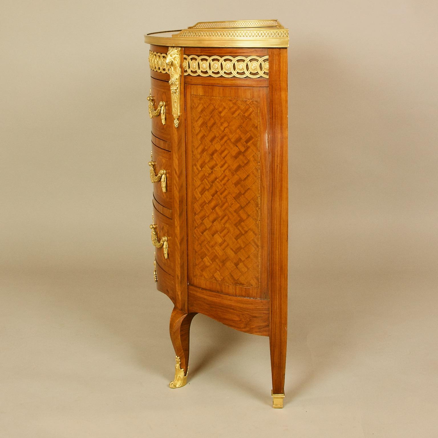 19th Century Louis XVI Marquetry and Gilt-Bronze Demilune Goat Heads Commode

An excellent 19th century Transitional /Louis XVI Style demilune or semi-elliptical commode or chest of drawers with fine cube-pattern marquetry: above a Neoclassical