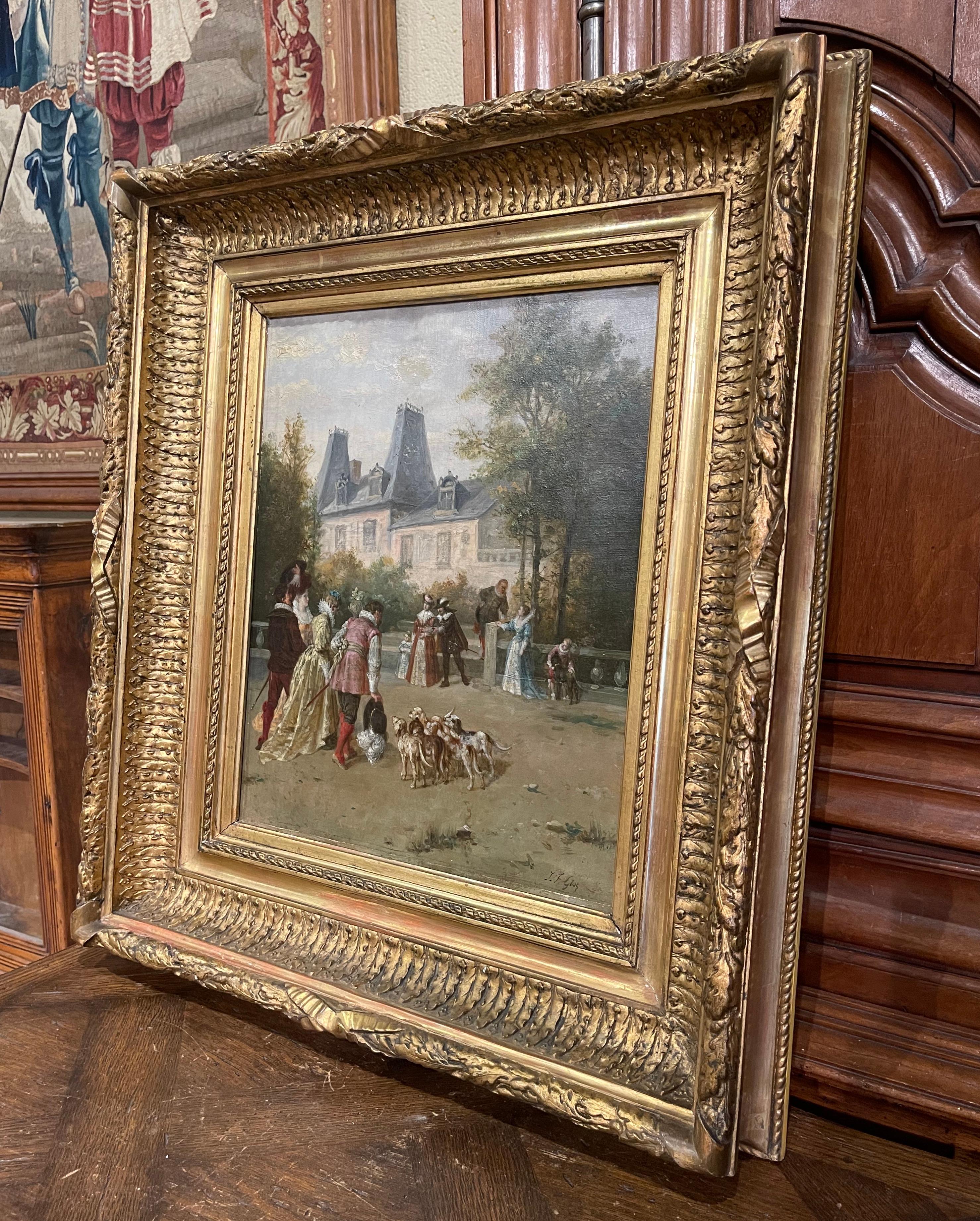 Created in France circa 1860 and set in the original carved gilt frame, the hand painted canvas depicts an outdoor scene with men and women in formal clothing talking in front of a castle; the scene is further embellished with a herd of dogs