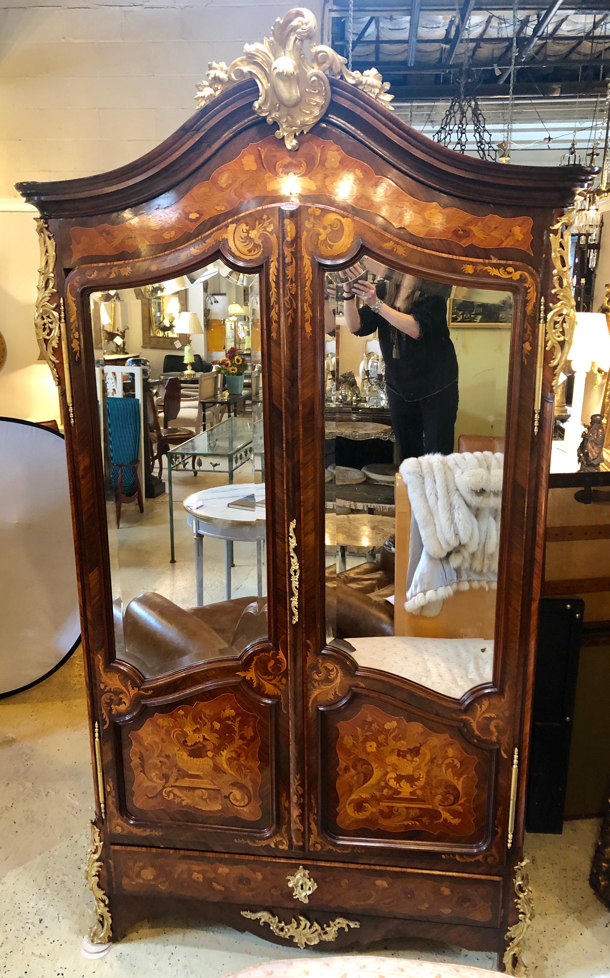 Simply Stunning and Spectacular Louis XVI Style Ormolu Bronze Mounted Marquetry Armoire. This late 19th or early 20th century cabinet is made of mixed woods having an inlaid case, ormolu mounts, mirrored doors, curly maple paneled interior with