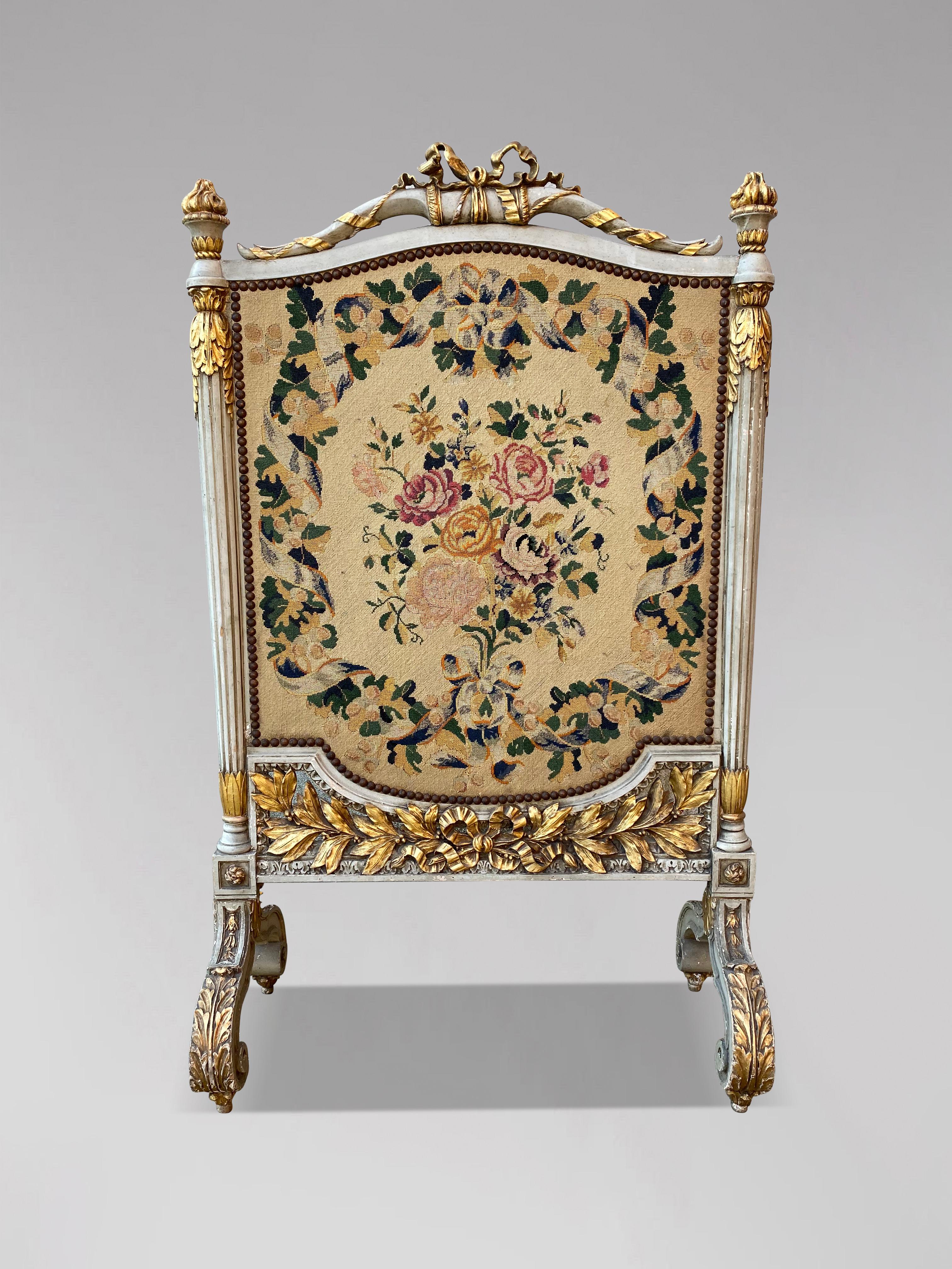 A very elegant 19th century carved and painted fireplace screen with gilded wood in the Louis XVI style, lined with a flower motif tapestry. Very decorative item, good quality with lovely carvings and beautiful patina.

The dimensions