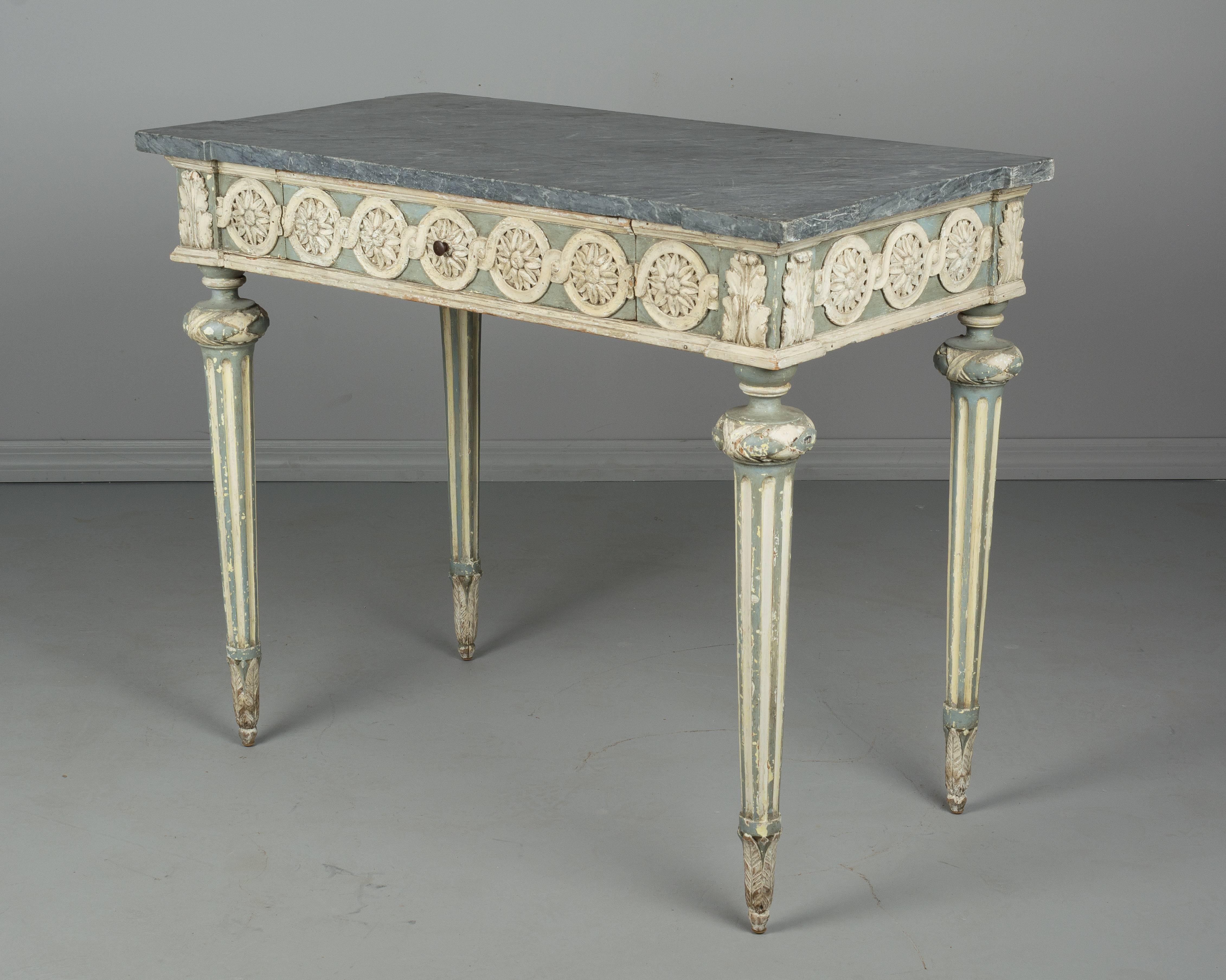 A 19th century French Louis XVI Provençal console made of pine with original pale Verdigris and cream painted finish. Hand-carved decoration and turned fluted legs. Single dovetailed drawer. Original grey marble top with notched corners. Please