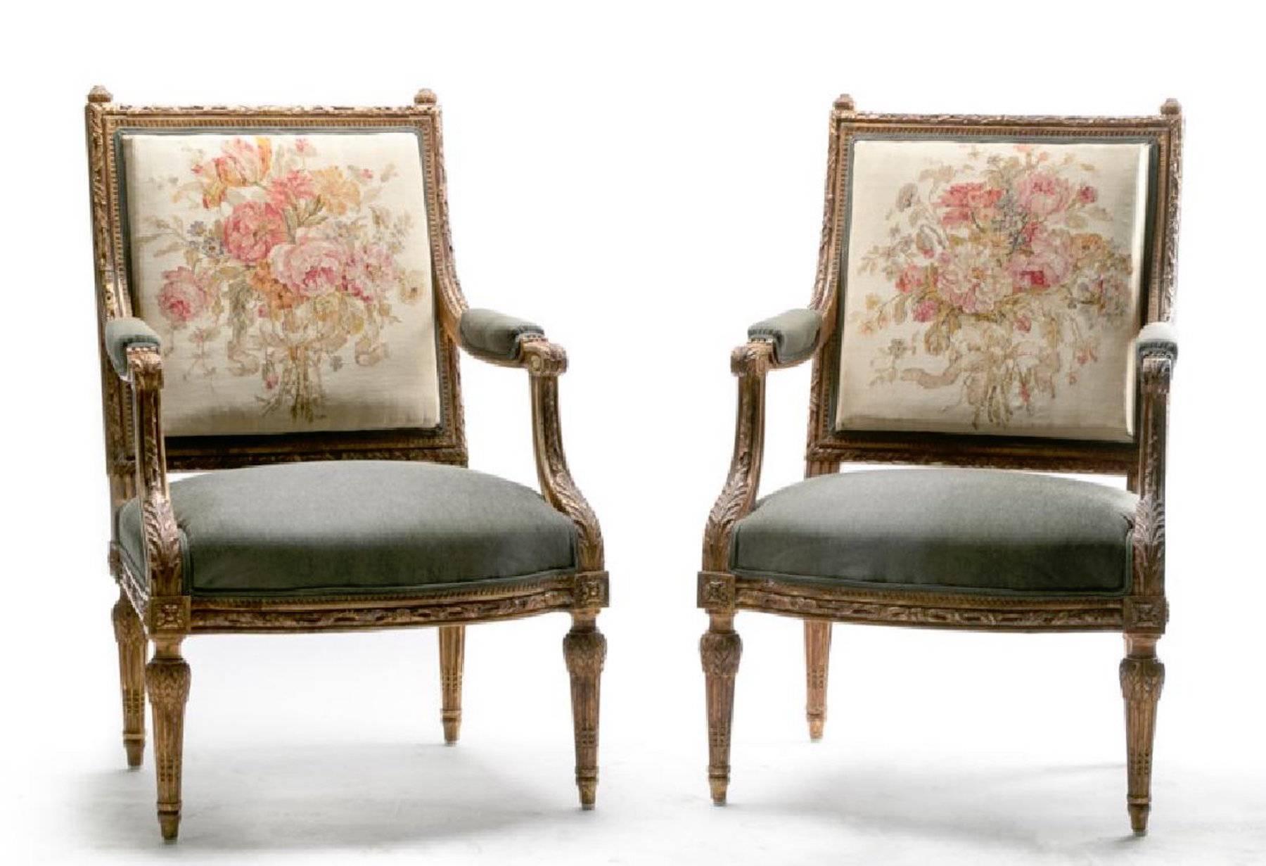 A pair of fauteuil a la Reine, with finely carved giltwood neoclassic frames. The back rest with handwoven Aubusson tapestry, the seats, arm rests and the backs are all newly upholstered in a custom silk wool blend.

