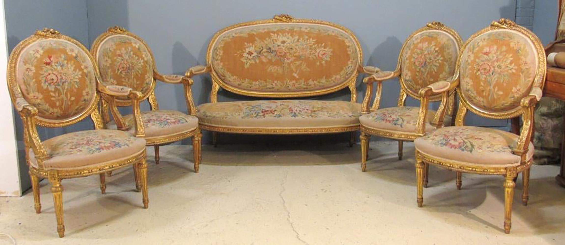 Finest 19th century Louis XVI style Aubusson salon / parlor set. A settee and four Fauteuil's comprise this stunning and breathtaking Salon Set. The Louis XVI Style Aubusson Upholstery is in very fine condition having vibrant colors in a floral