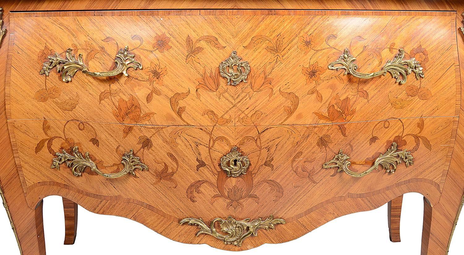 A good quality late 19th century marquetry inlaid kingwood commode, having its original marble-top, two large drawers, ormolu mounts and handles and raised on out swept legs.