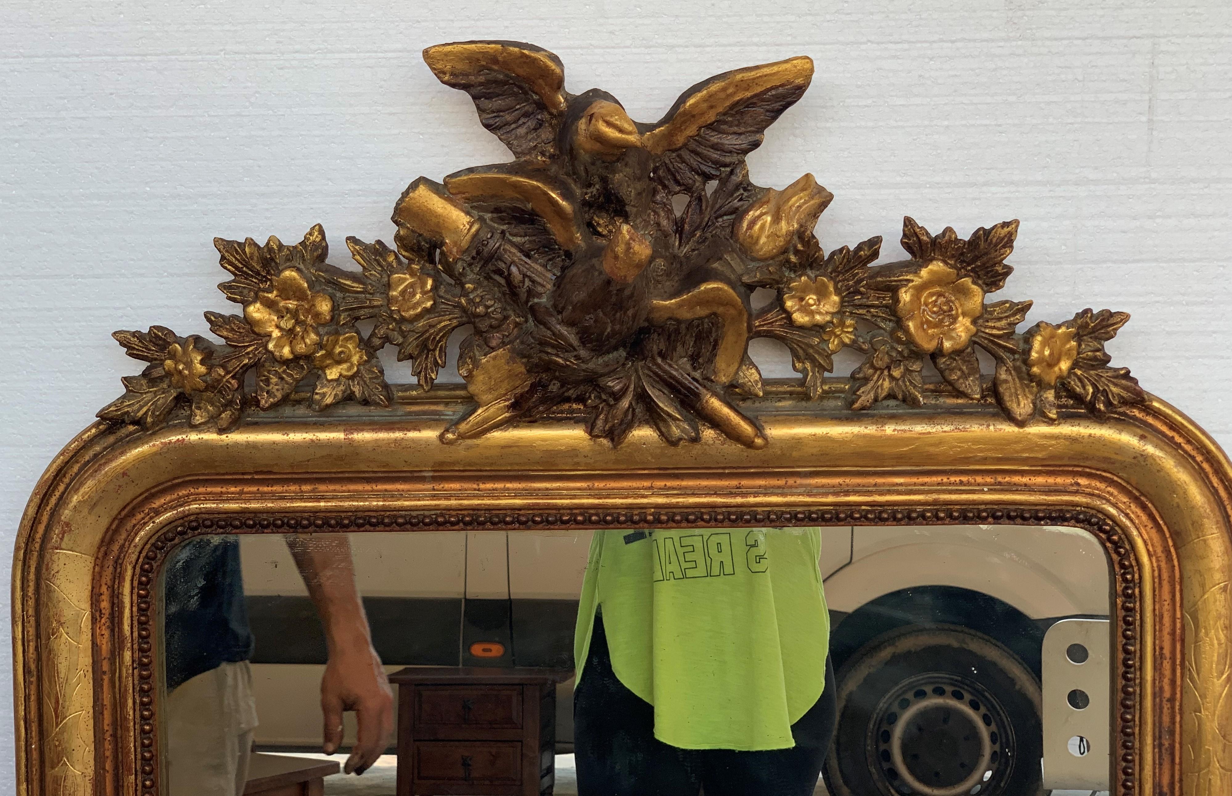 French 19th Century Louis XVI Style Carved Giltwood Mirror with Eagle and Floral Relief