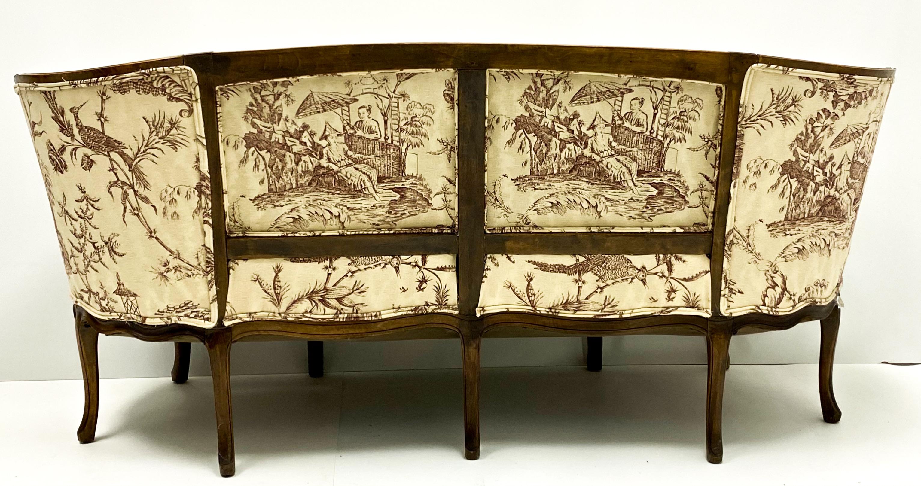 Love this! This is a 19th century Louis XVI style carved walnut French canapé in a chinoiserie linen. It is in very good condition, and the cushion is a nice plump down. The upholstery is recent appears to be a printed cotton- linen blend. The