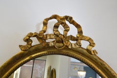 19th Century Louis XVI Style Gilded Oval Mirror, a Large Bow above the Frame