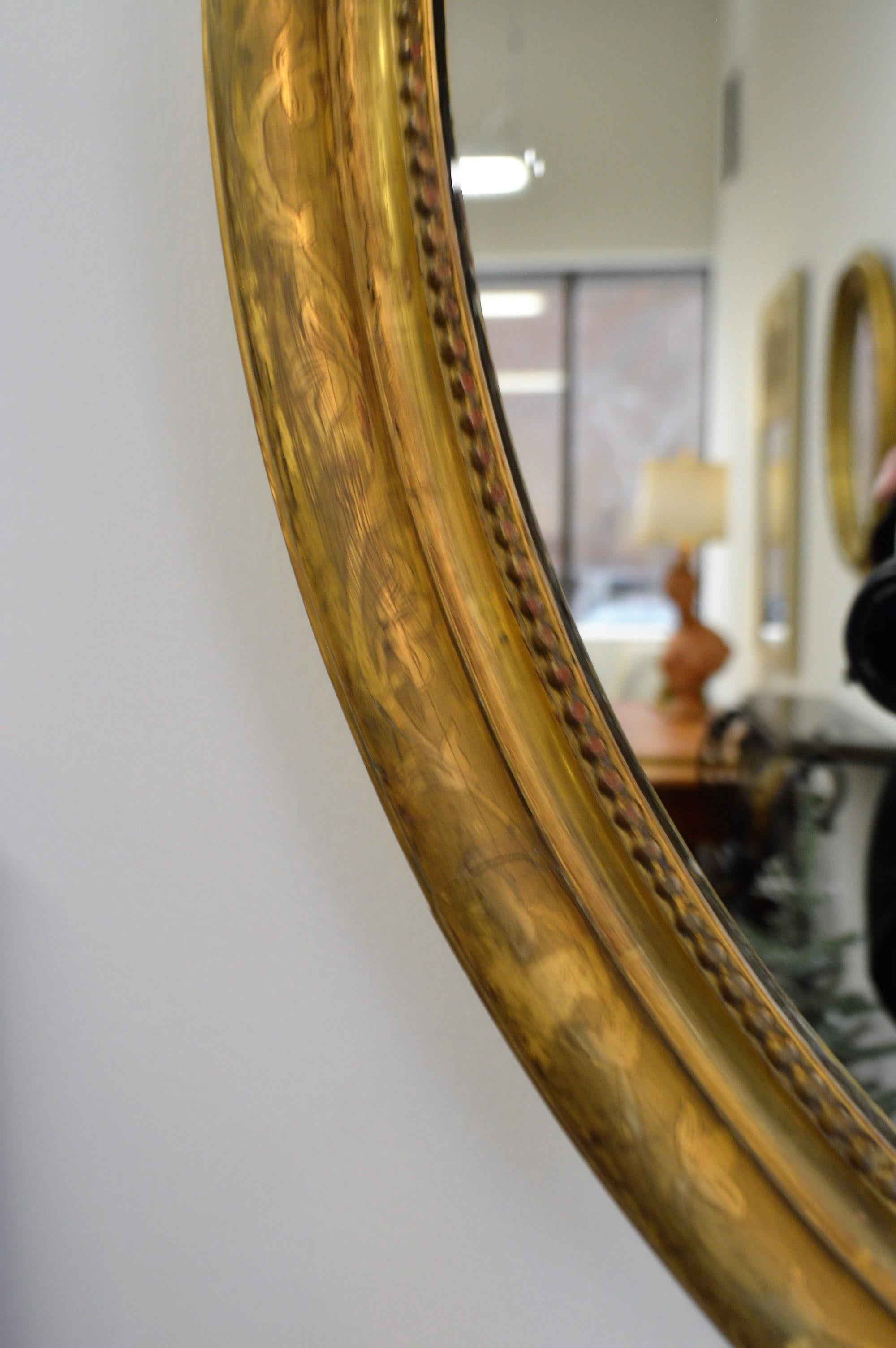 Gilt 19th Century Louis XVI Style Gilded Oval Mirror, a Large Bow above the Frame
