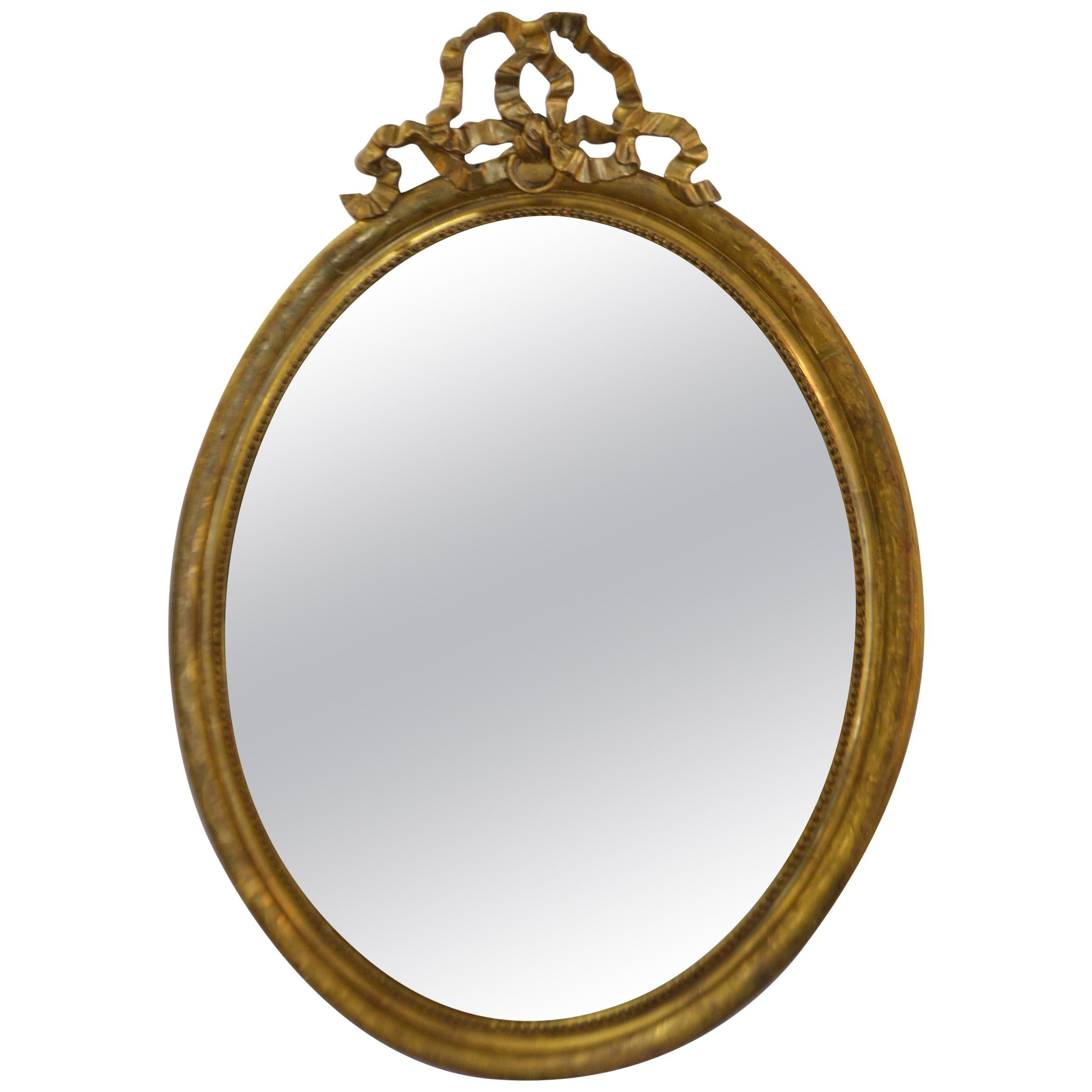 19th Century Louis XVI Style Gilded Oval Mirror, a Large Bow above the Frame