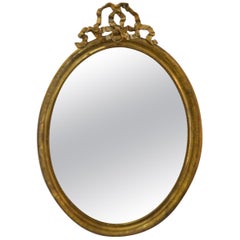 19th Century Louis XVI Style Gilded Oval Mirror, a Large Bow above the Frame