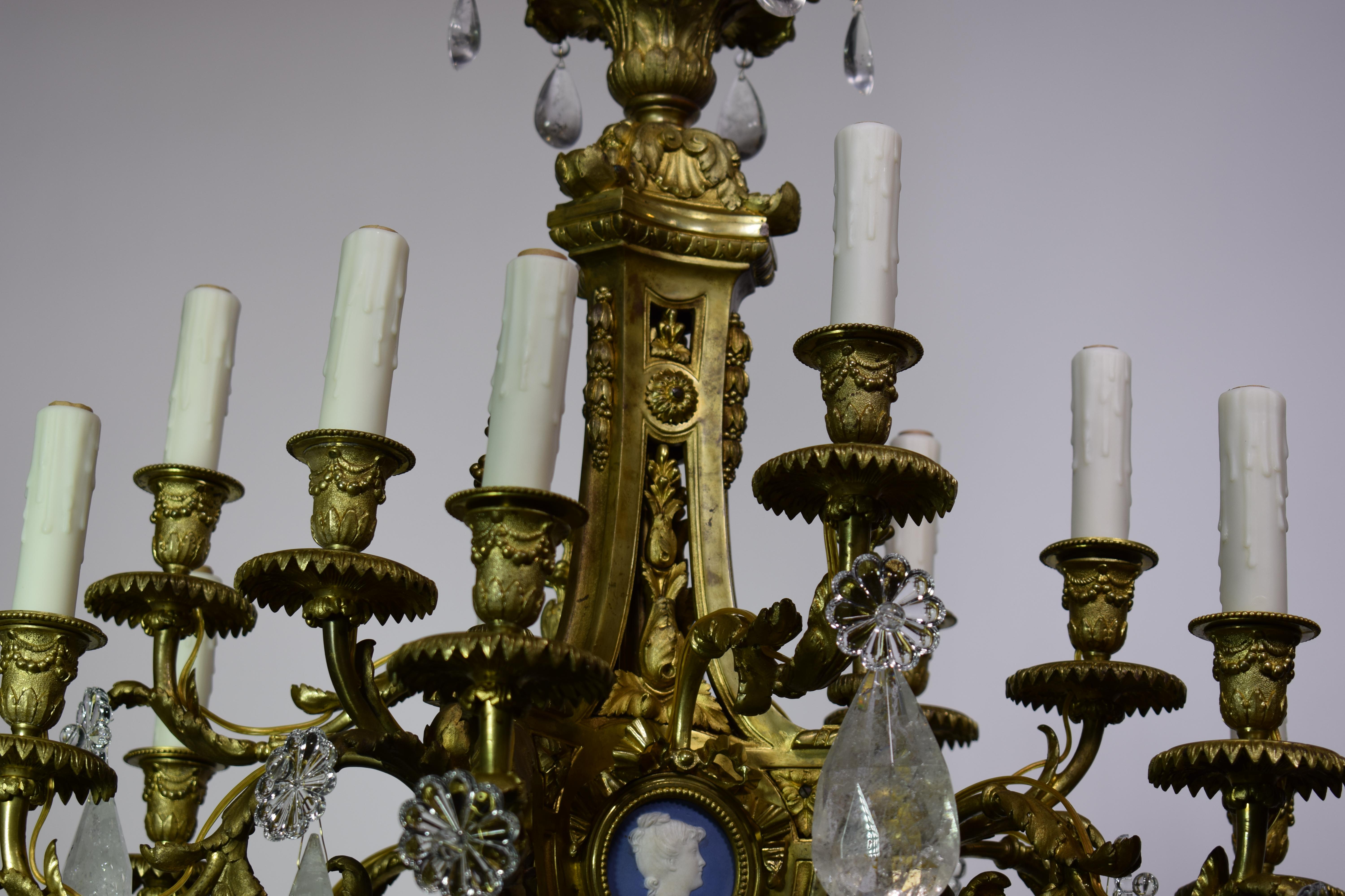A magnificent gilt-bronze, crystal and rock crystal, Louis XVI style chandelier, featuring round reserves fitted with round blue and white bisque cameos. This chandelier was originally used for candles, now electrified. France, circa 1880. 12