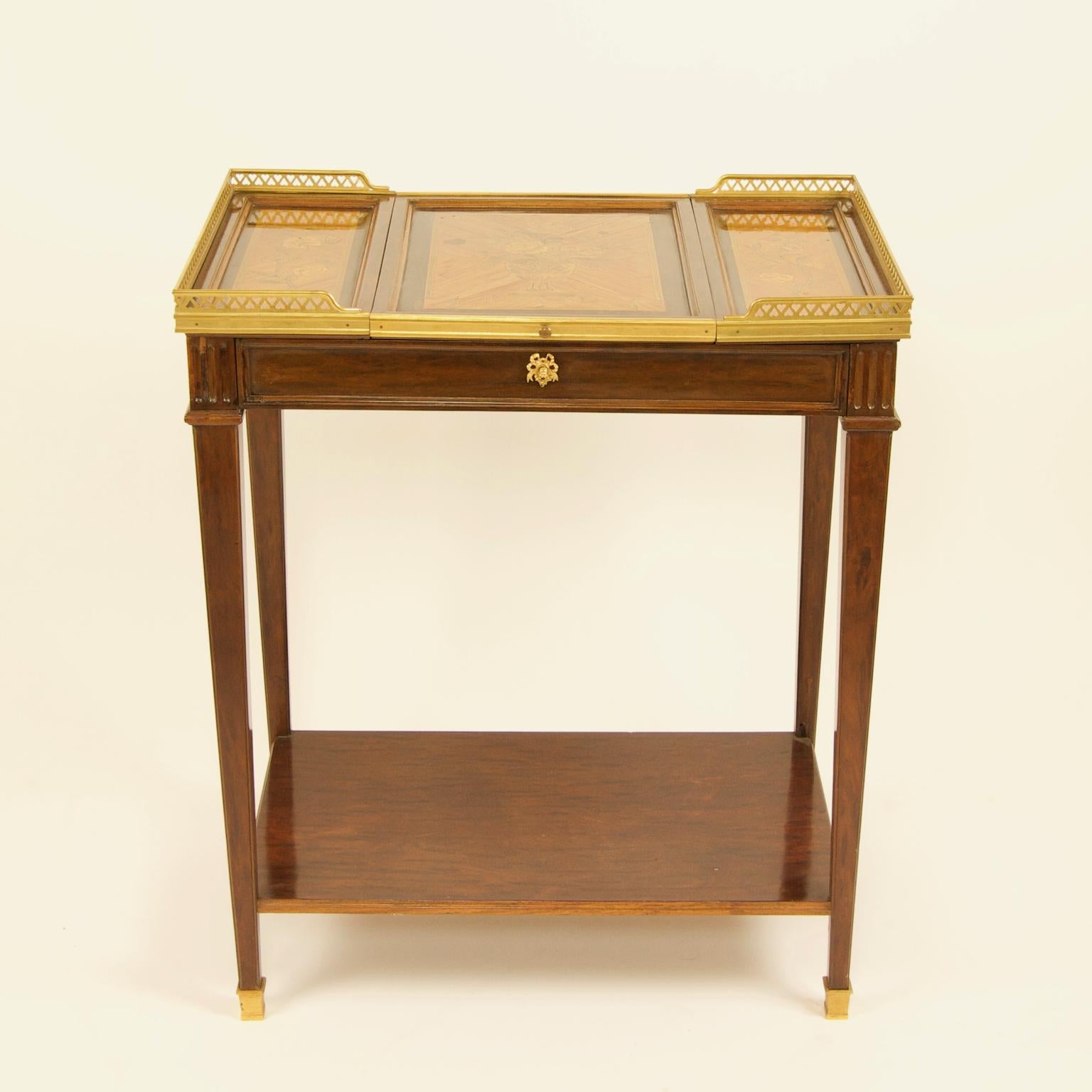 19th century Louis XVI style gilt bronze mounted floral marquetry poudreuse vanity or dressing table

A 19th century Louis XVI style gilt-bronze mounted marquetry poudreuse or dressing table standing on four slender tapering legs with gilt bronze