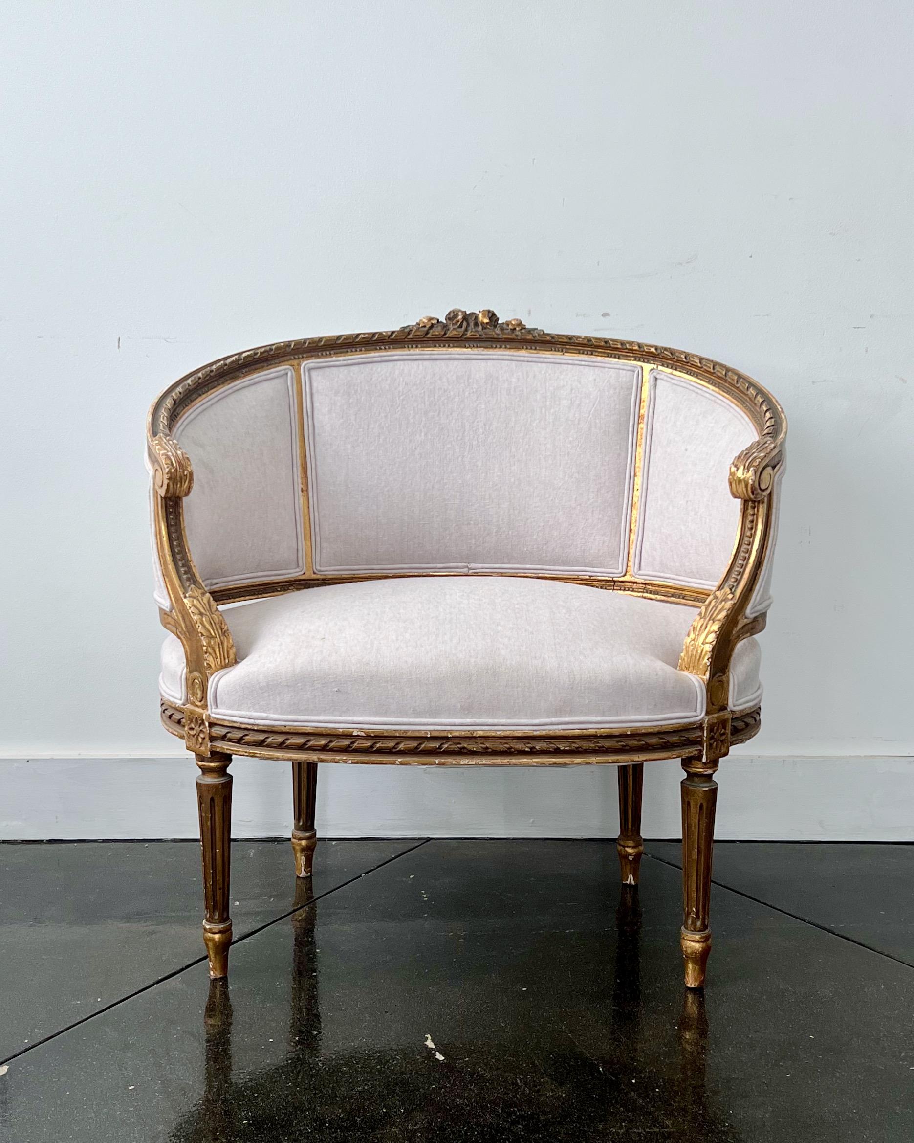 19th century French very wide and rare Bergère, Louis XVI style, called Marquise with coved back which sweep without a break in to the armrests. Richly carved back and seat rails on elegant fluted legs with flower carvings. Upholstered beautifully