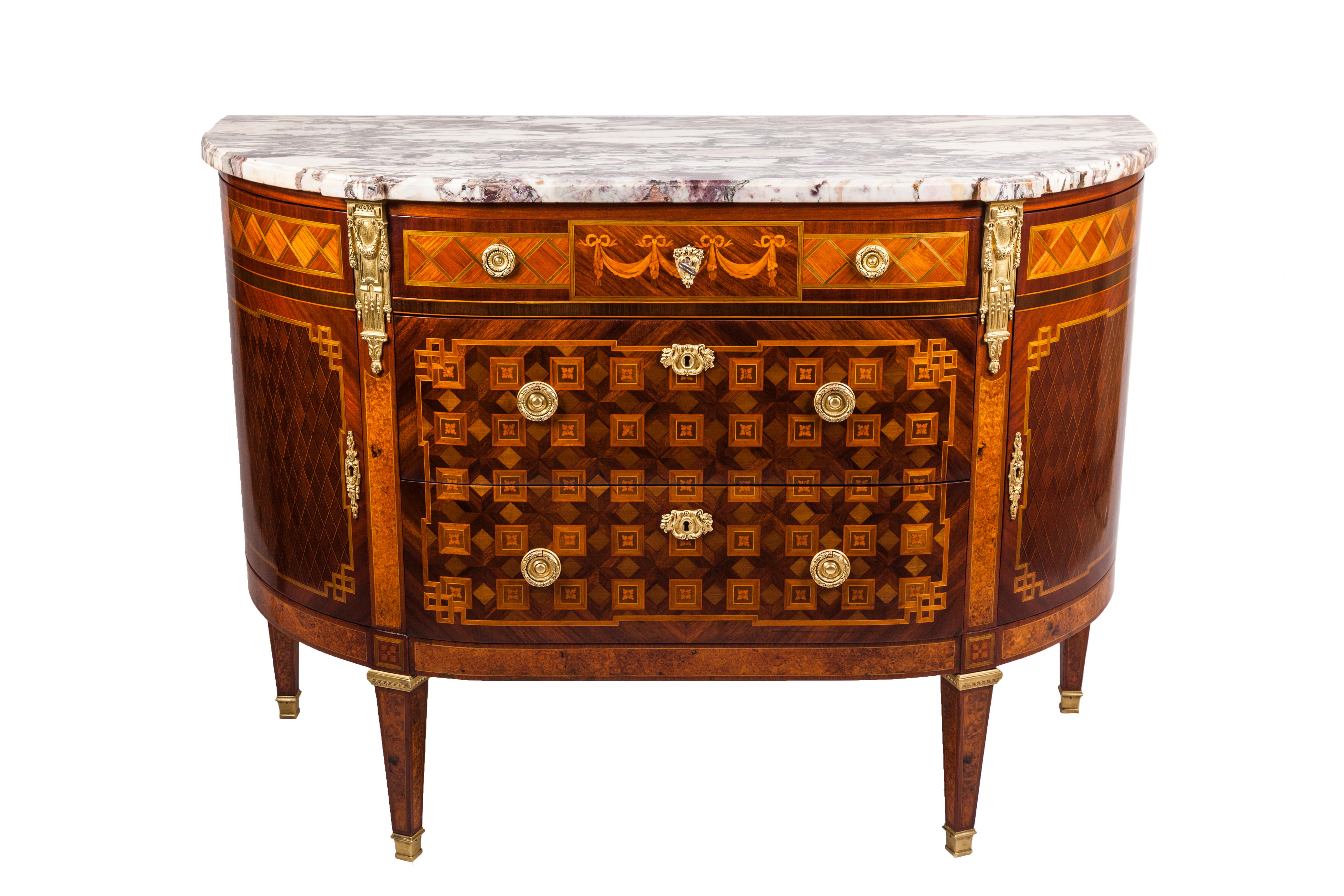 French dresser of the late 19th century. Furniture in Louis XVI style characterized by a pleasant geometric inlay made of rosewood, mahogany, maple, fruitwood, colored woods. 
Chest composed by two central drawers, three small drawers on the top