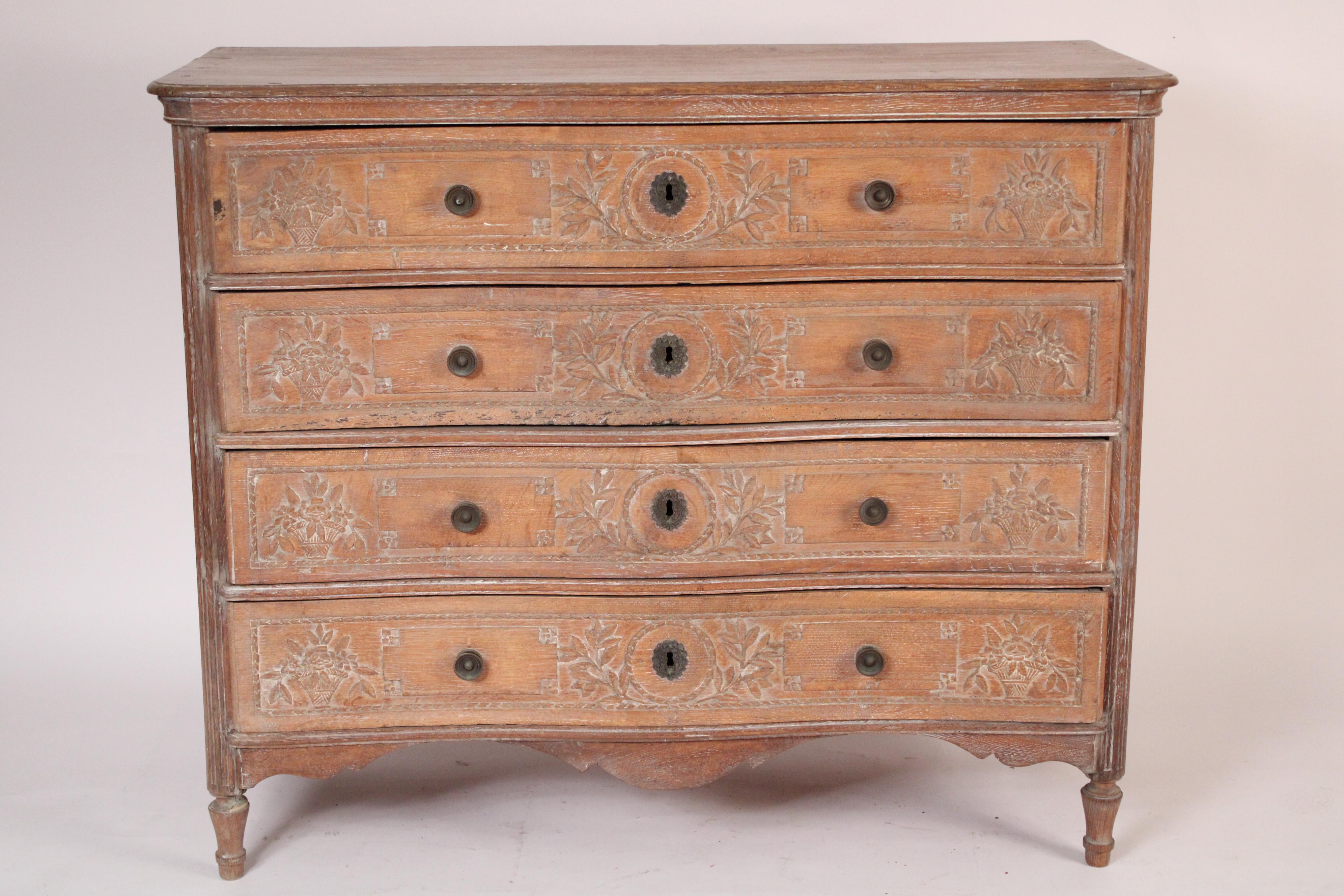 Antique Louis XVI style limed oak 4 drawer chest of drawers, 19th century. With a rectangular top with molded front and side edges and a serpentine shaped front edge, 4 serpentine shaped drawers with floral carving and brass escutcheons and brass