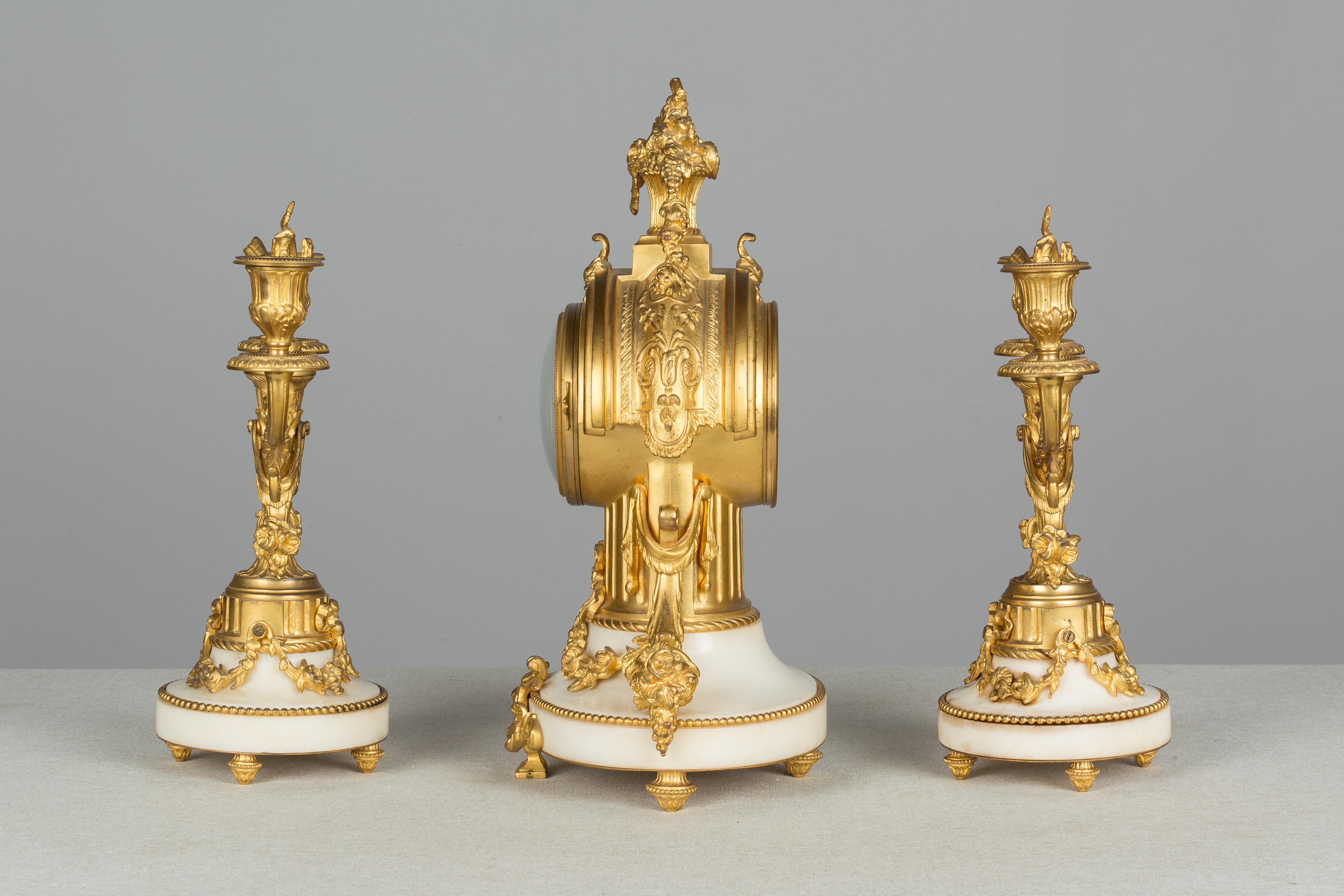 French 19th Century Louis XVI Style Mantle Clock and Candelabras