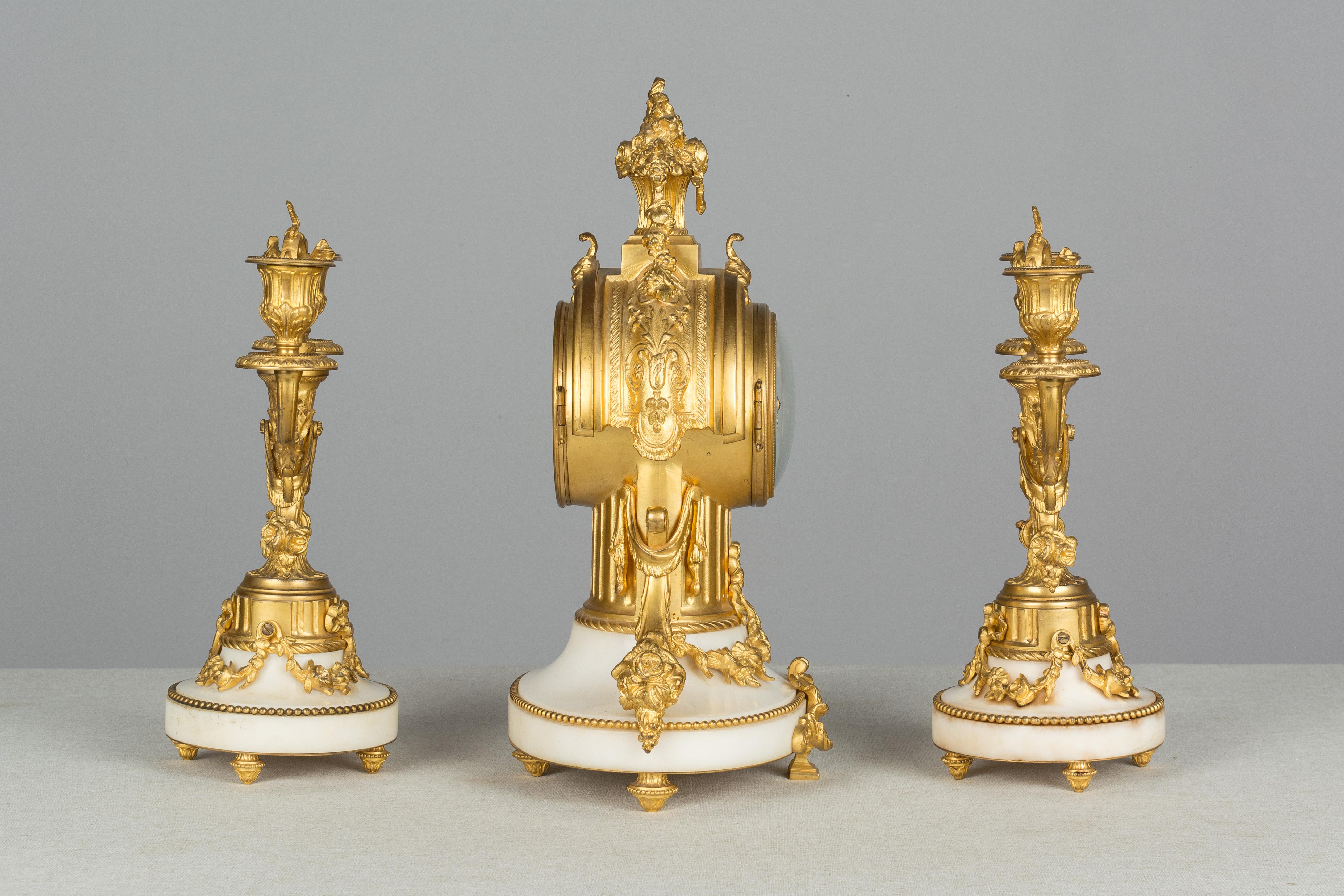 Cast 19th Century Louis XVI Style Mantle Clock and Candelabras