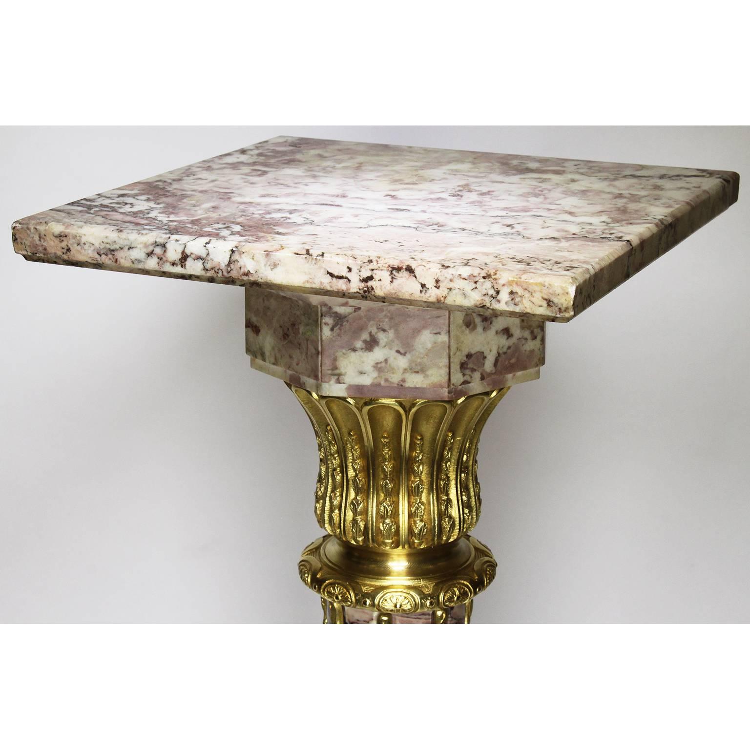 A fine and tall French 19th century Louis XVI style Brêche Violette marble and gilt bronze-mounted pedestal stand. The slender fluted and tapered marble body surmounted with a scalloped peacock and rosette shaped supports with gilt bronze floral
