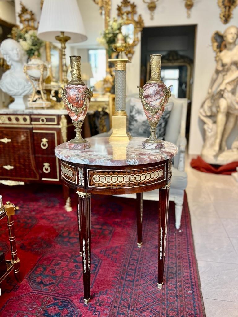 This exquisite late 19th-century directoire Louis XVI style guéridon features intricate marquetry with a diamond inlay as well as a frieze drawer. The design of this piece is enriched by an abundance of gilded bronze decorations, such as asparagus