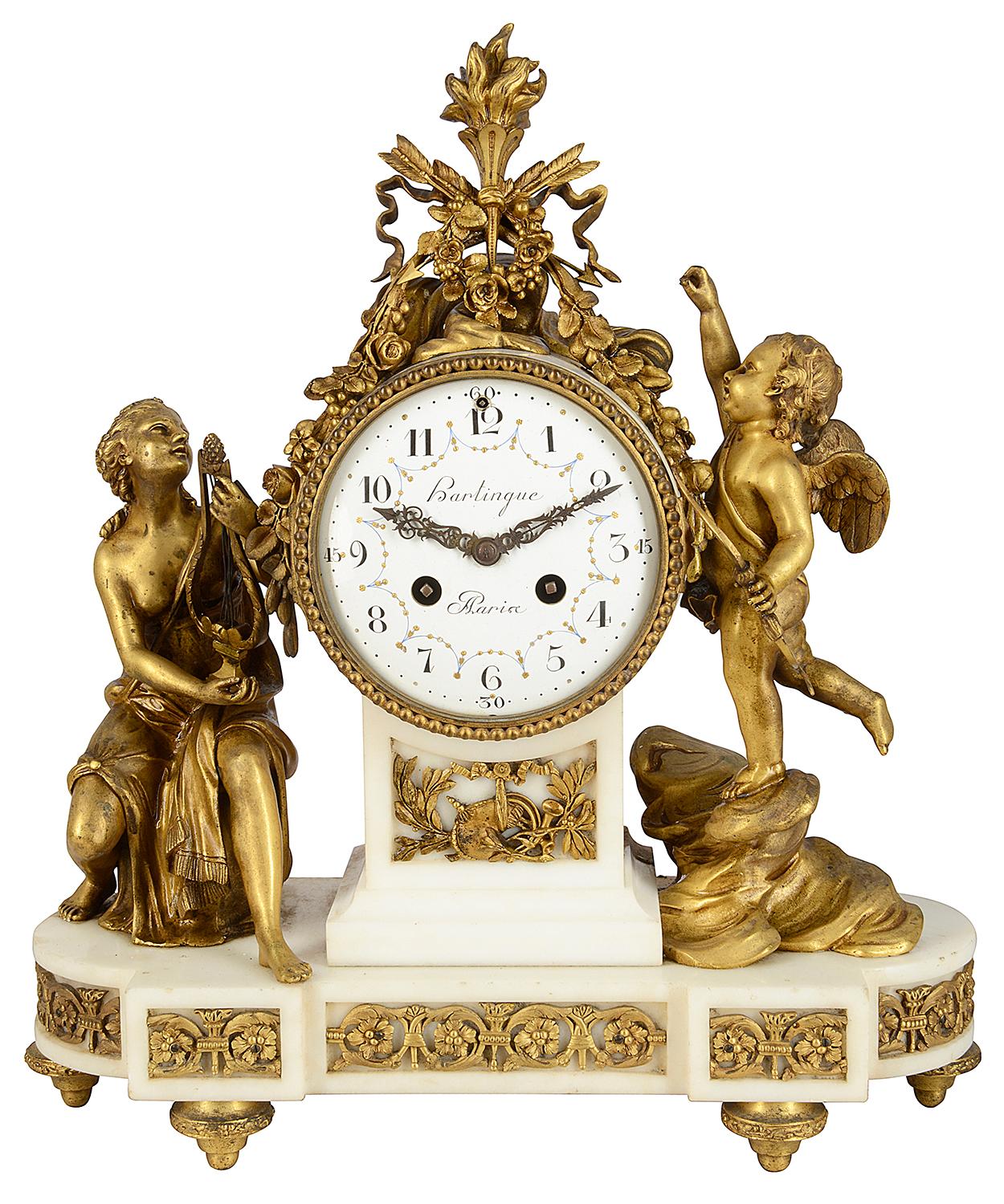 A very good quality classical 19th century French gilded Ormolu mantel clock set, with a flame, arrows and ribbons above a white enamel clock face, an eight day duration chiming clock movement. A seated semi nude maiden playing a harp and a cupid