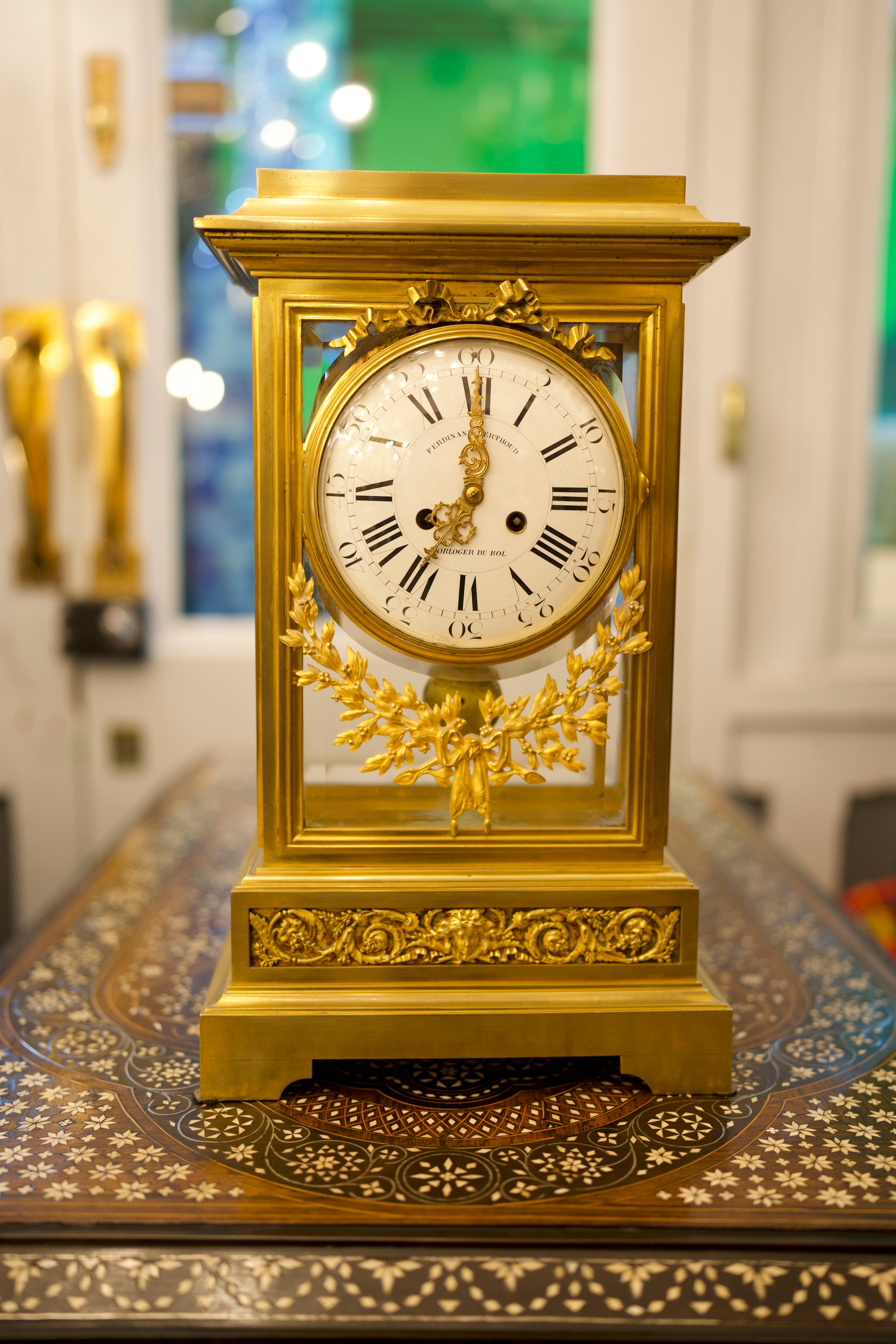 A stunning 19th Century Louis XVI Style Regulator Gilt Bronze clock by Ferdinand Berthoud.
A French Louis XVI style gilt bronze regulator clock, the finely cast rectangular case with four beveled glass sides; the large white enamel dial with Roman