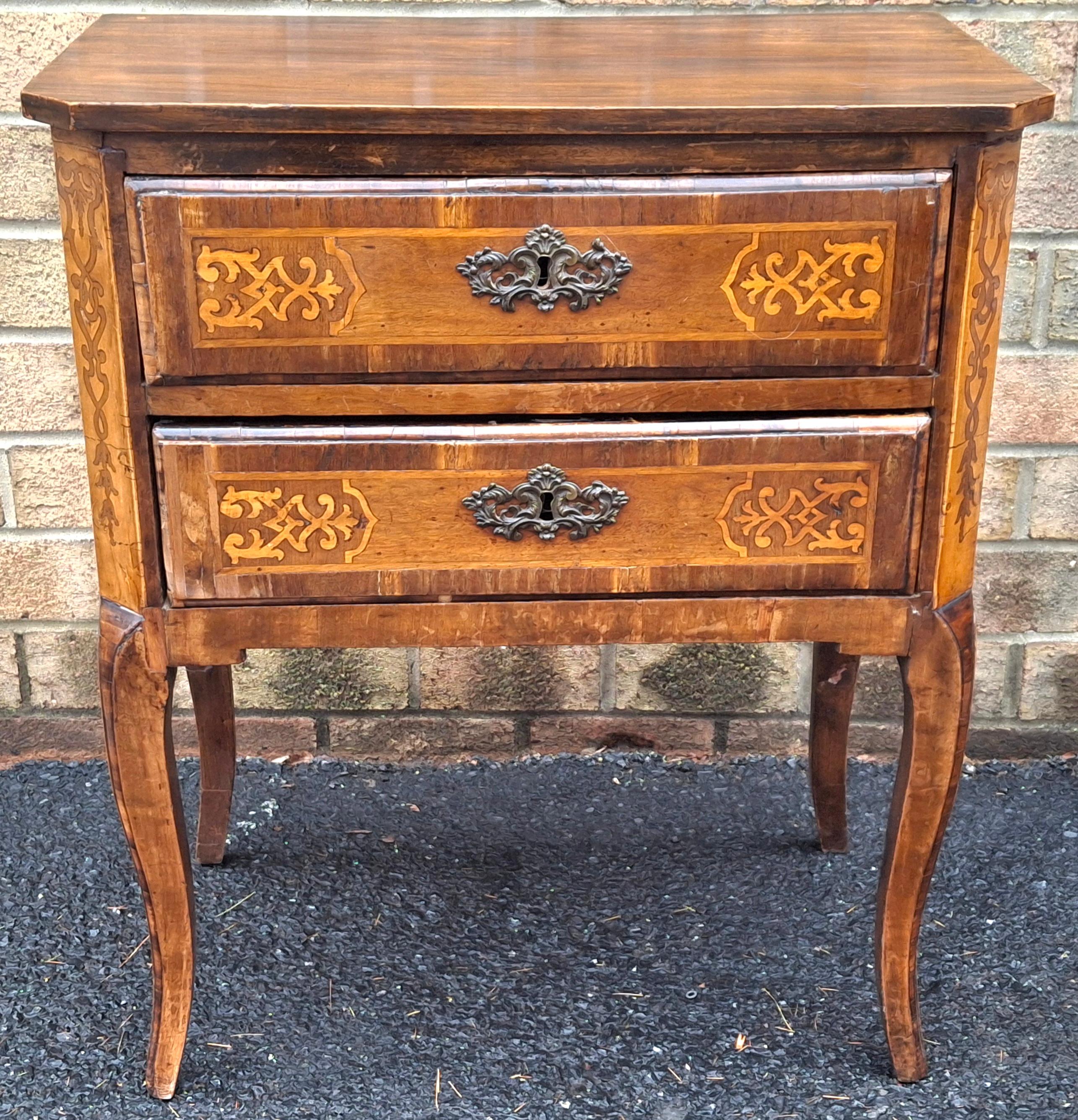 An antique French Louis XVI Style Mahogany Two-drawer chest / bedside table  with intricate multi-pattern Satinwood inlay veneer work and original ornamental bronze escutcheons. 
Great in any room in your home.
Measures: 26