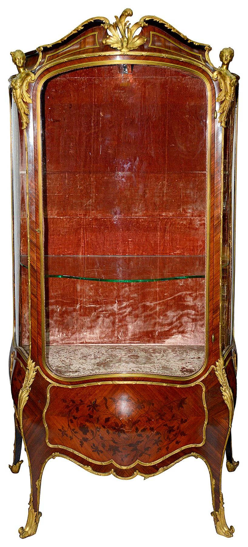 A fine quality 19th century French Louis XVI style bombe fronted vitrine, having wonderful quality gilded ormolu female monopodia mounts, floral marquetry inlaid panels to the sides and door front, that opens to reveal adjustable glass shelves