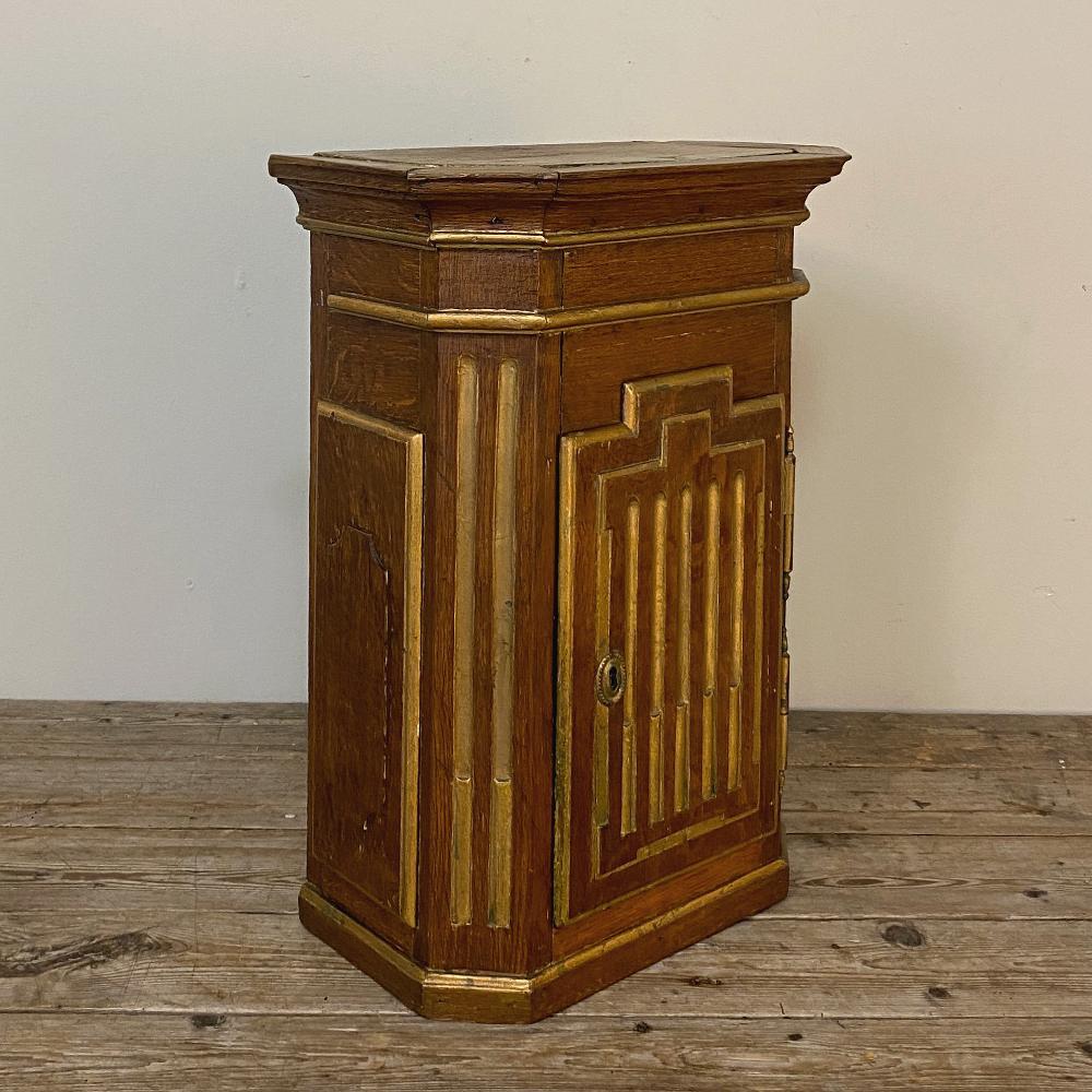 19th century Louis XVI wall cabinet is a charming diminutive piece that is perfect for cozy niches, bathrooms and water closets! The boldly molded crown combines with the stepped-up door design and mitered corners to create architectural interest,