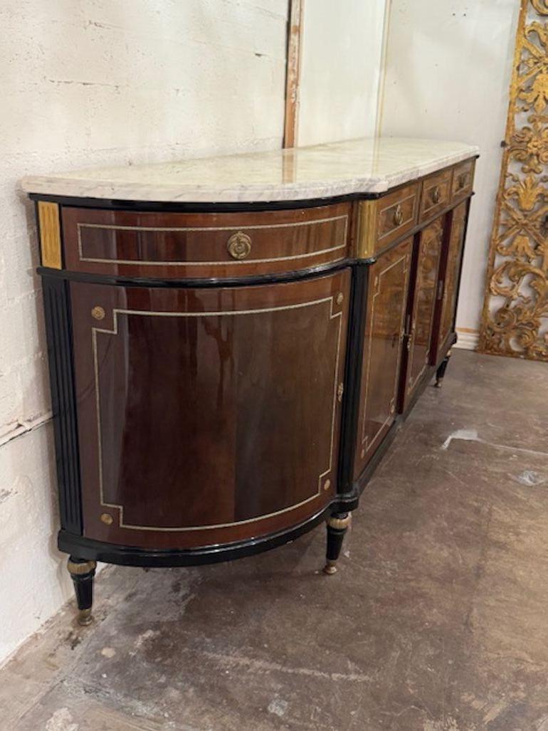 The 19th Century Louis XVI Walnut Sideboard with Marble Top is a luxurious and elegant piece of furniture from the early 19th century. Crafted with fine quality materials, this sideboard features a sophisticated design inspired by the French Louis