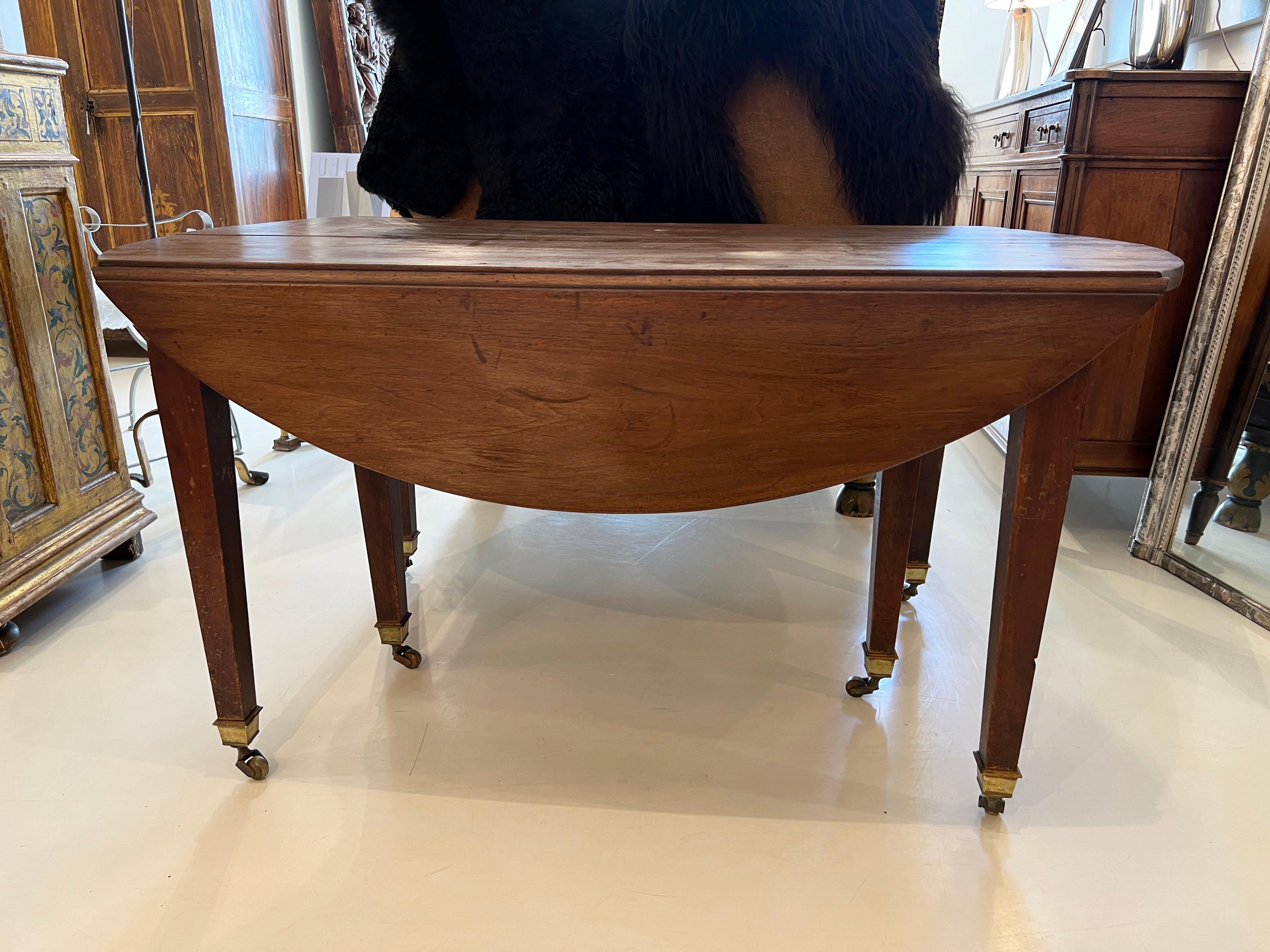 Six leg expandable table with drop leaves.  Additional leaves would have to be made.  The legs have brass fittings at the bottom with brass wheels.
