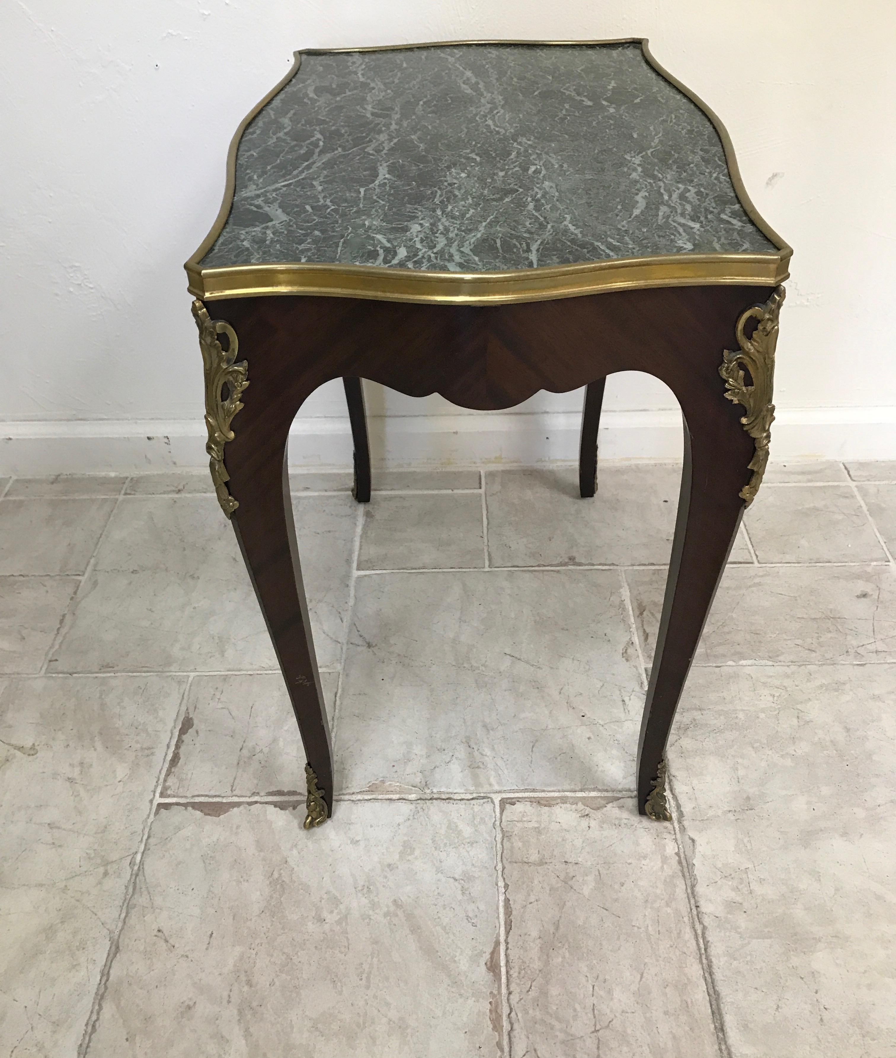 Dark green marble topped Louis XV style end table with ormolu trim.