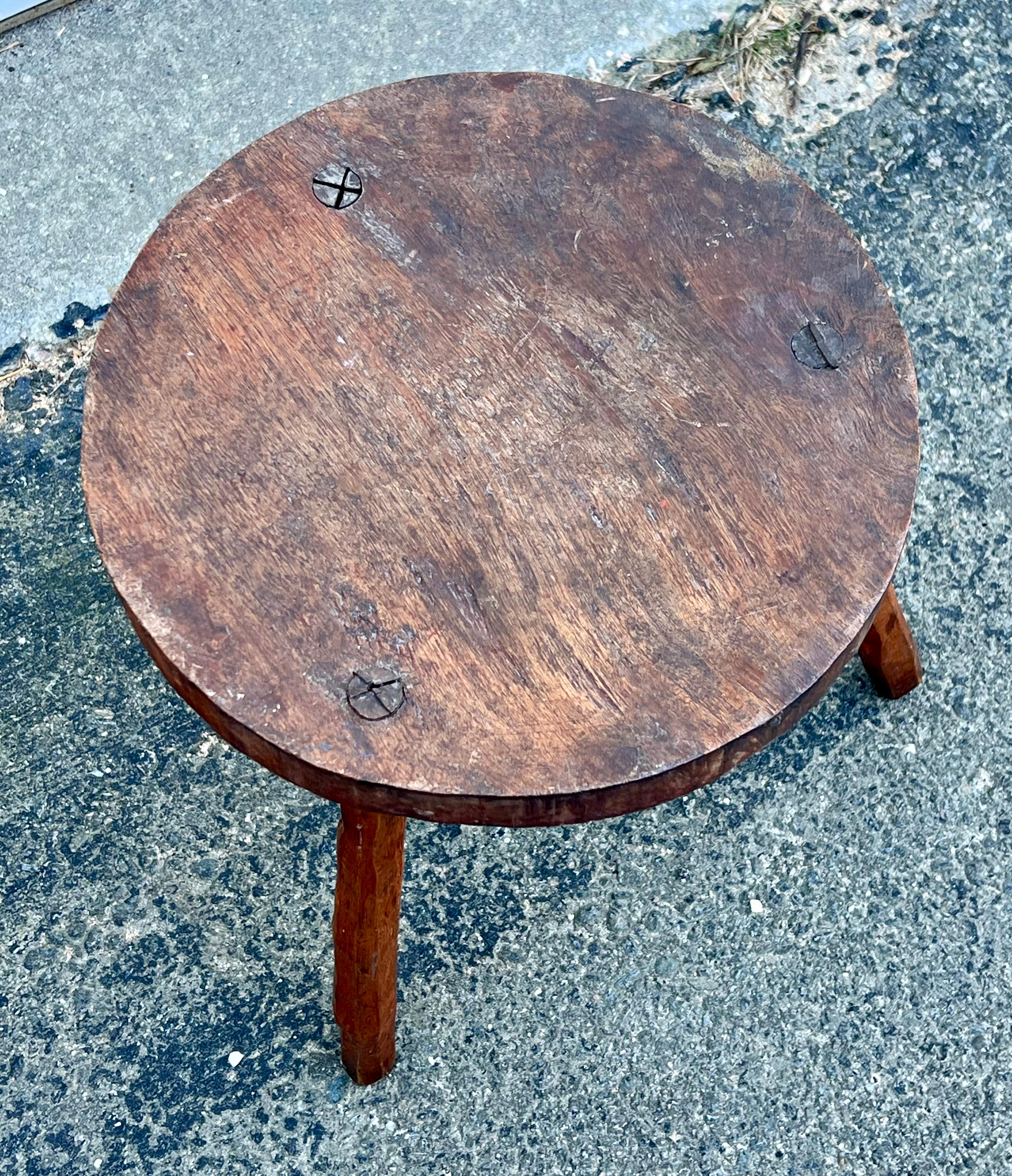 Stout little 19th century country joint stool with sturdy plank seat and low legs.